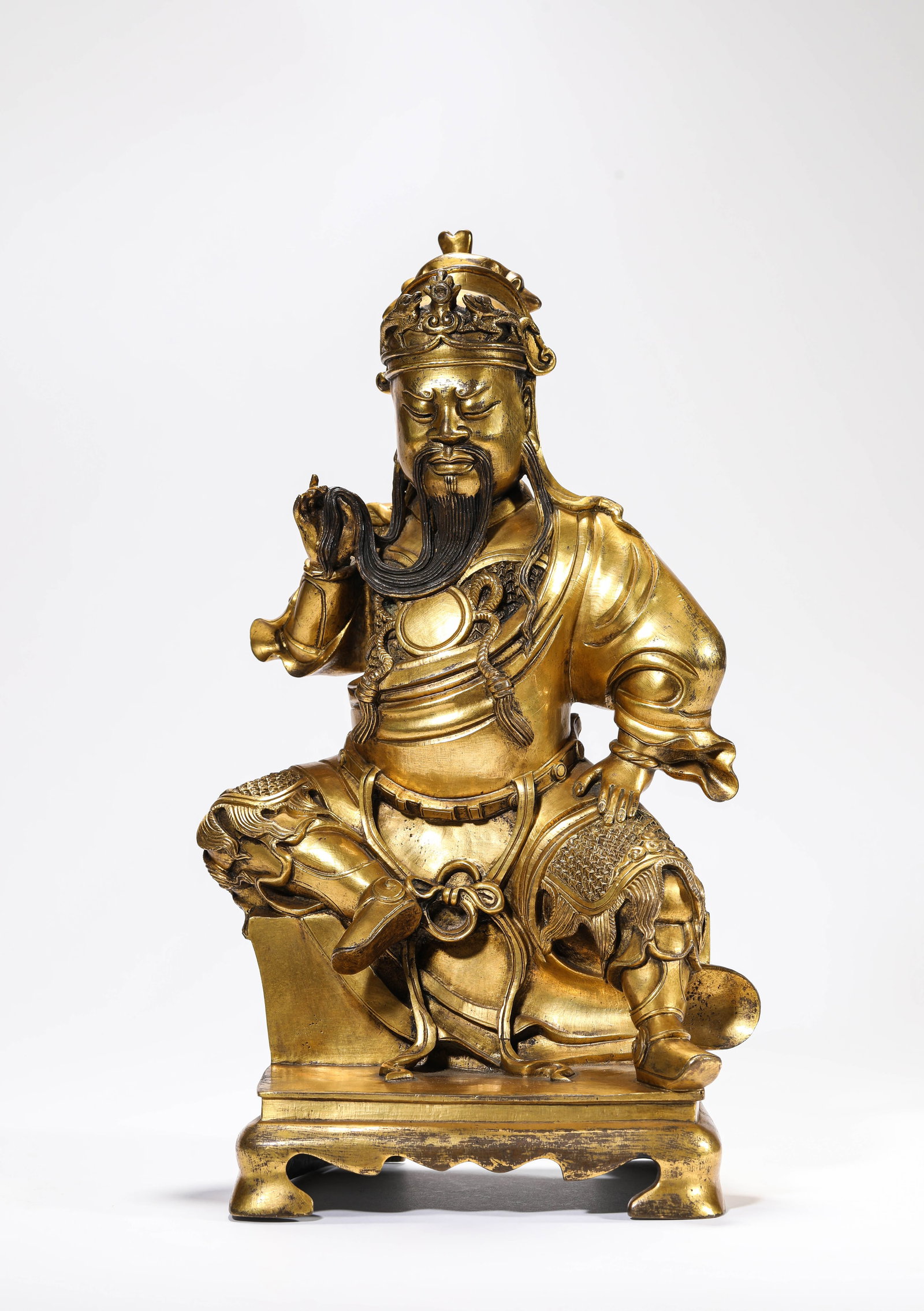 A GILT-BRONZE FIGURE OF GUAN YU: A GILT-BRONZE FIGURE OF GUAN YU Description: Dimensions: Weight: 4200 g. Length: 20 cm x Width: 13.6 cm x Height: 34.5 cm. All measurements are approximate.