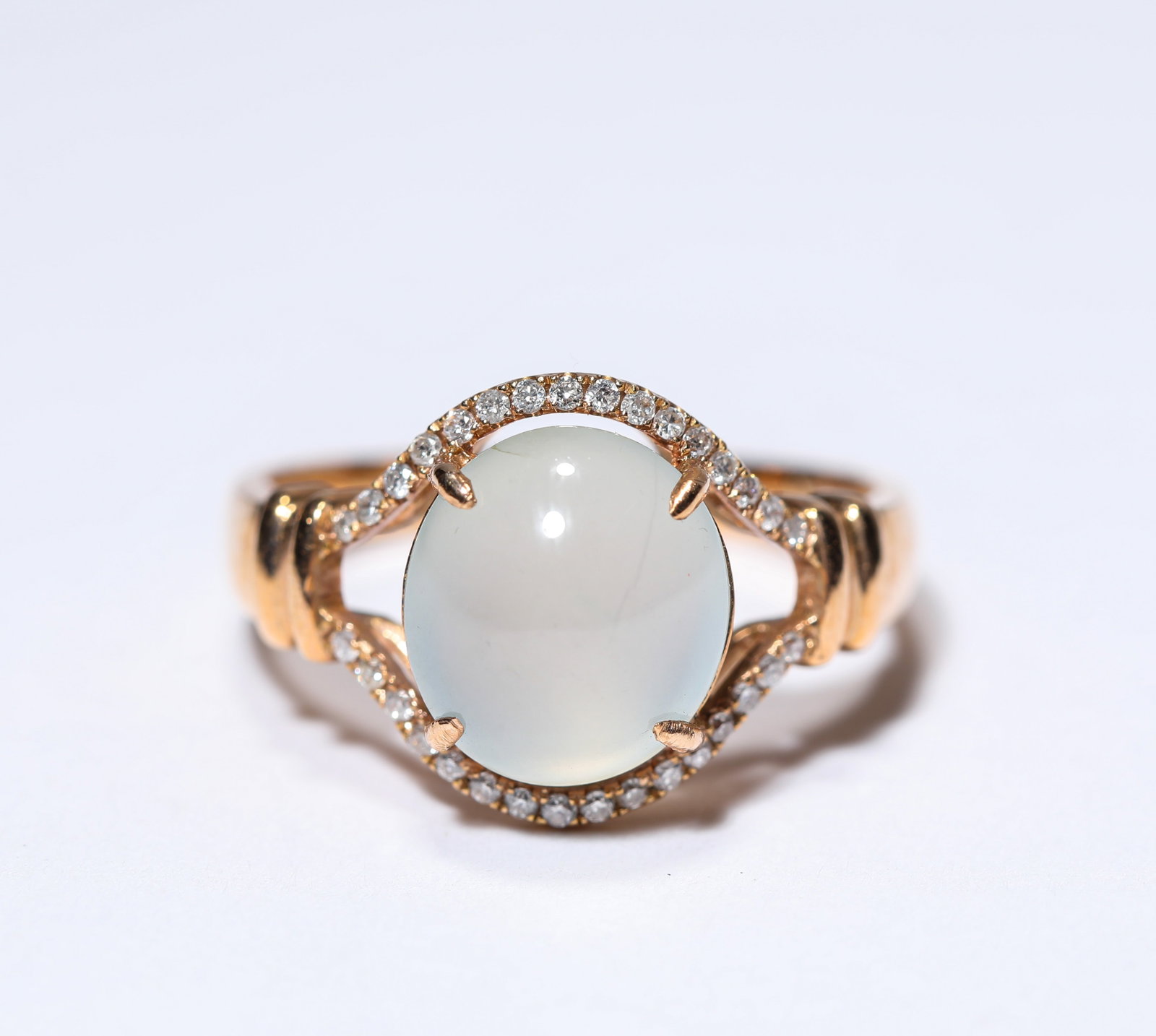 A JADEITE AND GOLD RING: A JADEITE AND GOLD RING Description: Dimensions: Weight: 3 g. Width: 1.6 cm. All measurements are approximate.