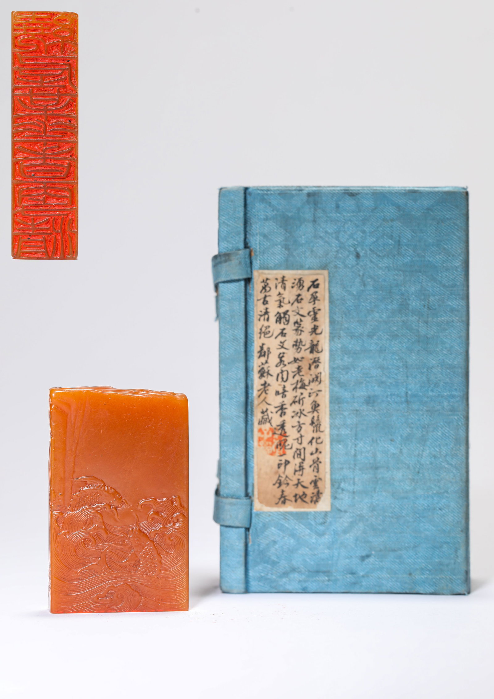 A TIANHUANG STONE 'CARVED FISH LEAPING OVER THE DRAGON GATE' SEAL: A TIANHUANG STONE 'CARVED FISH LEAPING OVER THE DRAGON GATE' SEAL Description: Dimensions: Length: 3.7 cm x Width: 1 cm x Height: 6.1 cm. All measurements are approximate.