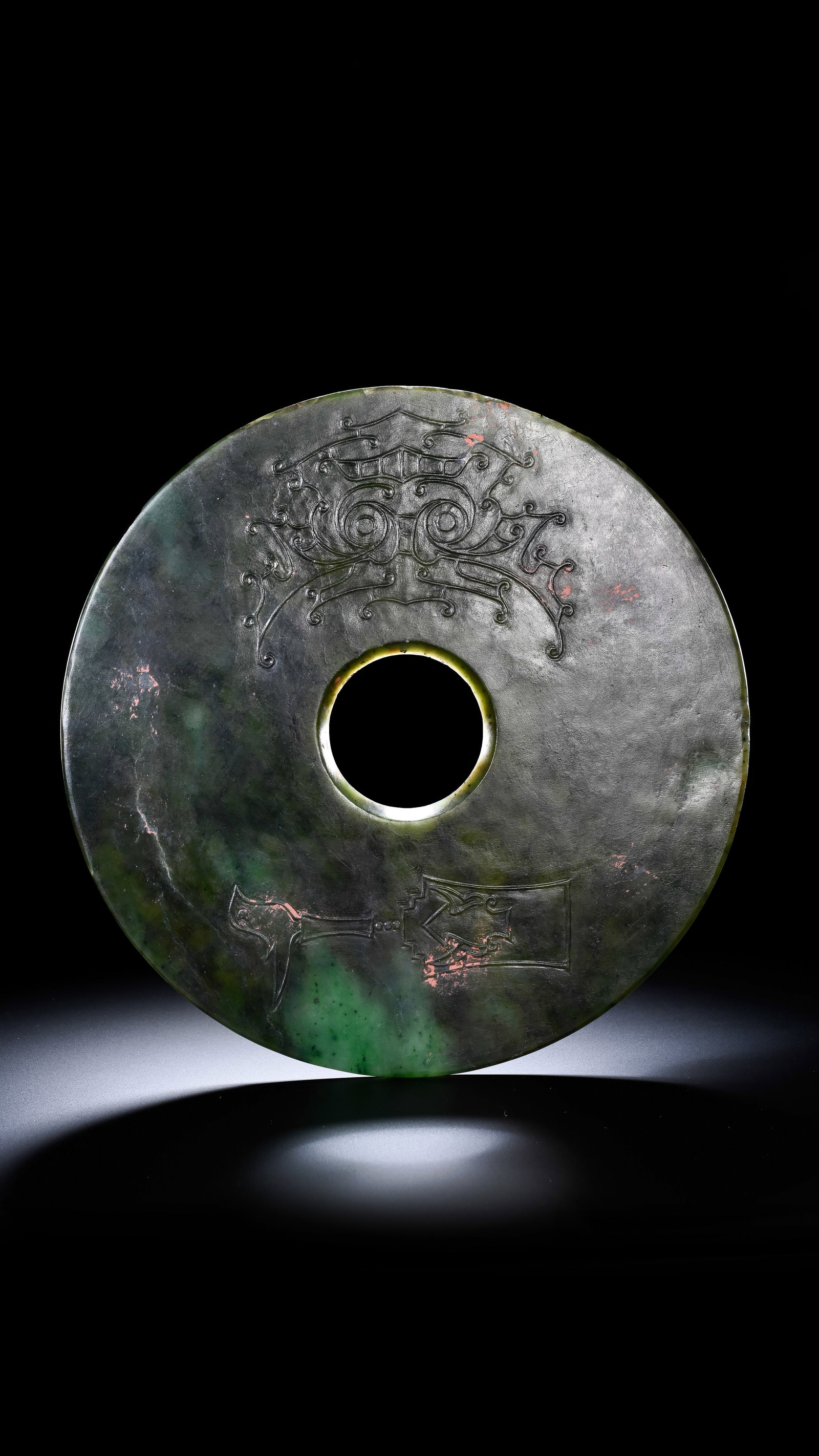 A SPINACH JADE 'ANIMAL MASK' BI DISC: A SPINACH JADE 'ANIMAL MASK' BI DISC Description: Dimensions: Width: 20 cm. All measurements are approximate.