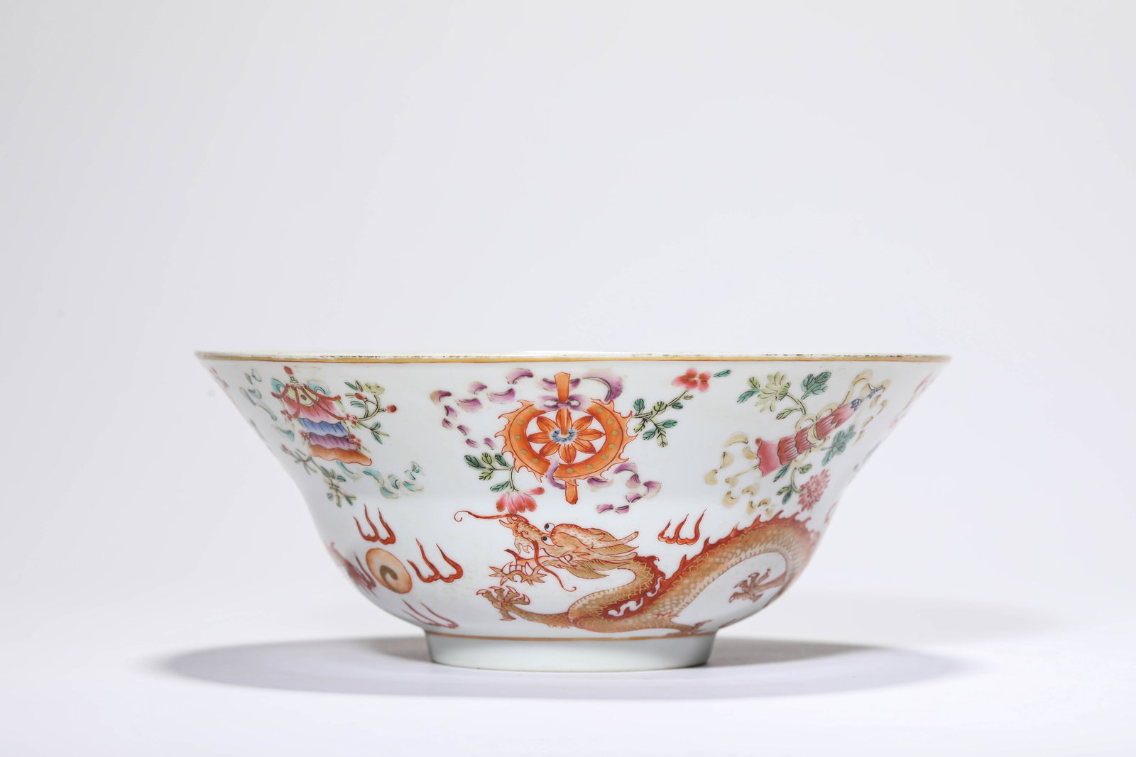 A FAMILLE-ROSE GILT-DECORATED 'DRAGON CHASING A PEARL AND EIGHT BUDDHIST EMBLEMS' BOWL: A FAMILLE-ROSE GILT-DECORATED 'DRAGON CHASING A PEARL AND EIGHT BUDDHIST EMBLEMS' BOWL Description: Dimensions: Width: 18.6 cm x Height: 7.6 cm. All measurements are approximate.