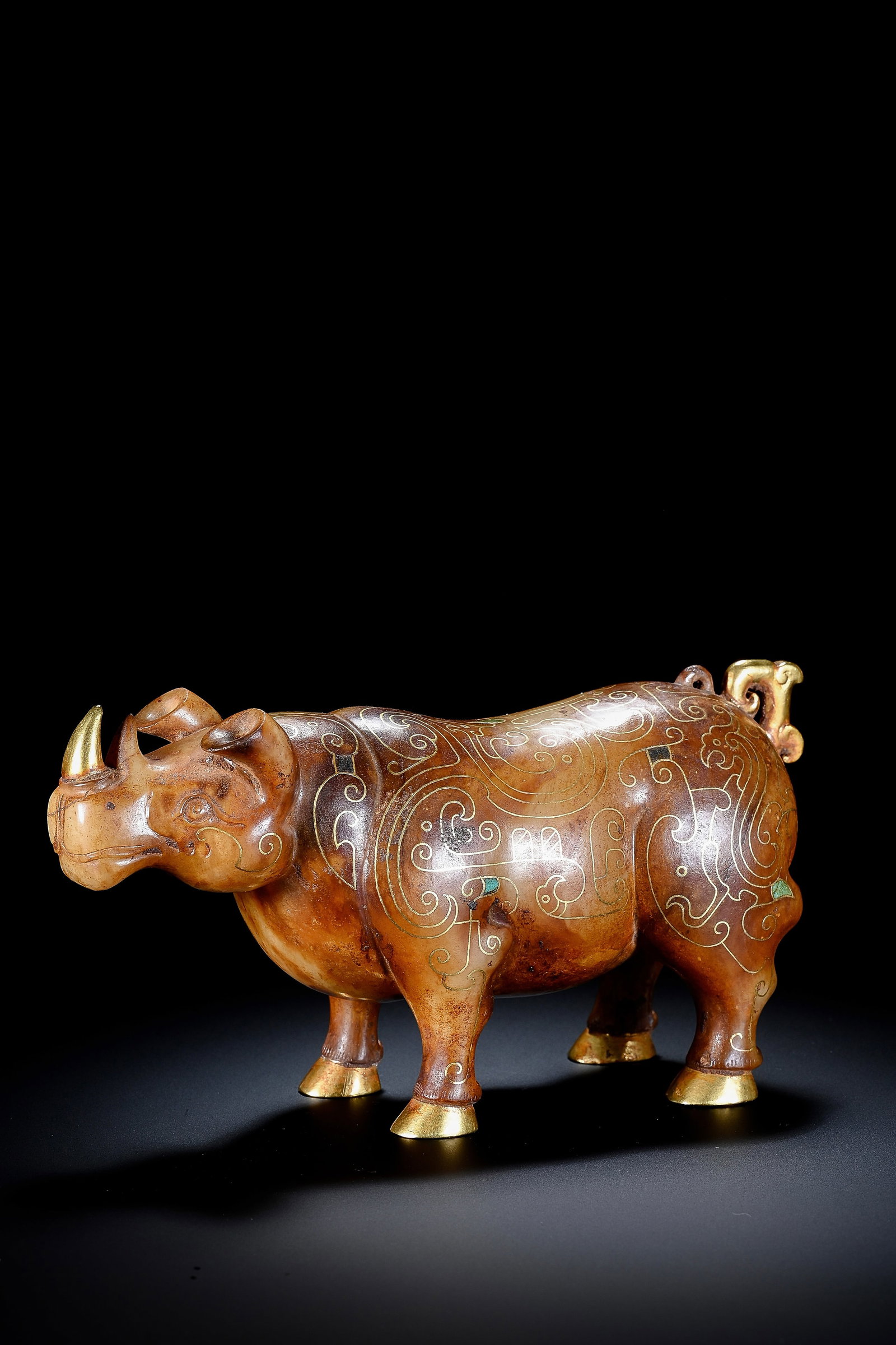 A JADE, GOLD AND TURQUOISE-INLAID RHINOCEROS: A JADE, GOLD AND TURQUOISE-INLAID RHINOCEROS Description: Dimensions: Width: 15.5 cm x Height: 8.5 cm. All measurements are approximate.