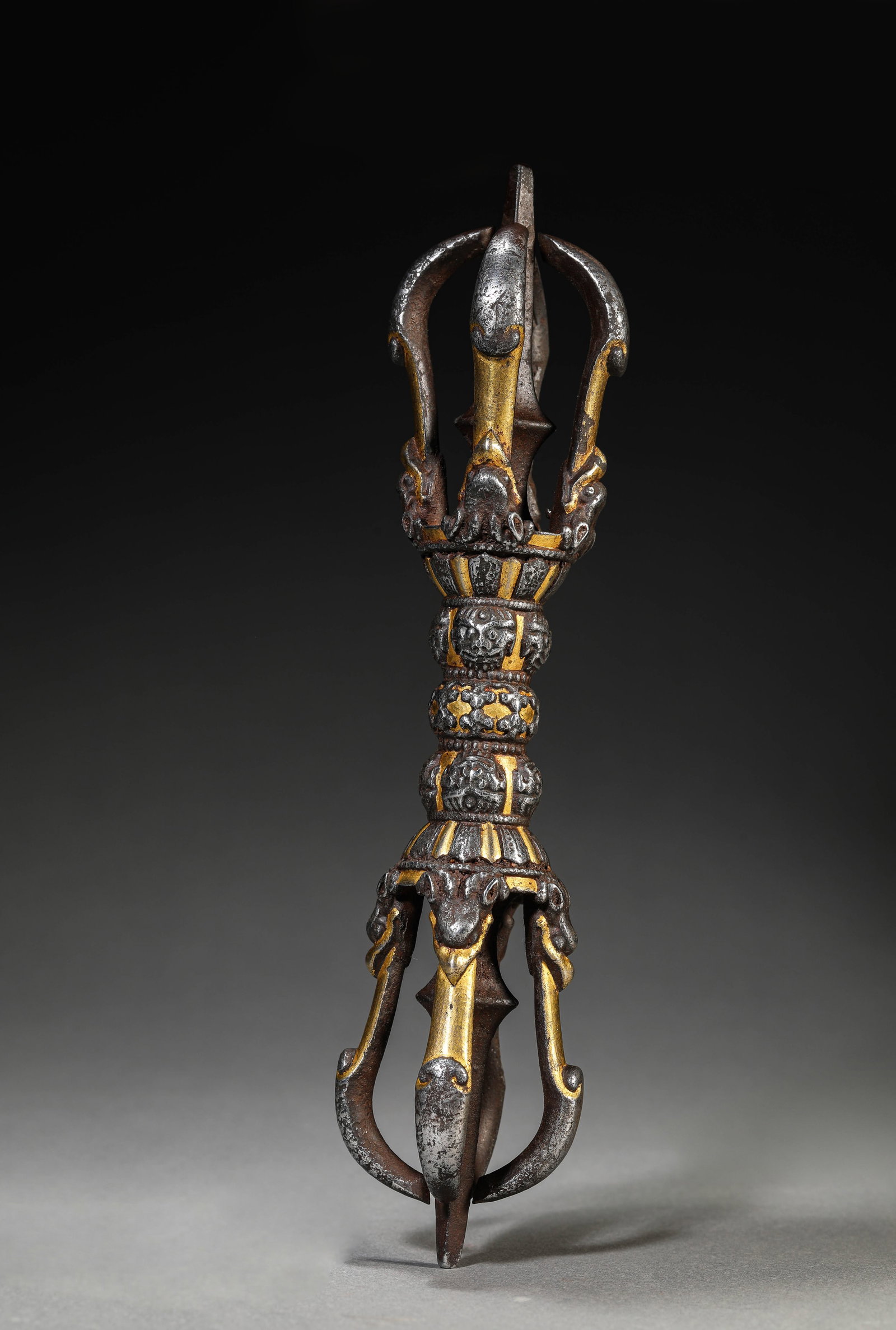 A TIBETAN IRON AND GOLD CHAMPLEVE 'FIVE-PRONGED' VAJRA: A TIBETAN IRON AND GOLD CHAMPLEVE 'FIVE-PRONGED' VAJRA Description: Dimensions: Weight: 534 g. Length: 22.3 cm x Width: 4 cm x Height: 4 cm. All measurements are approximate.