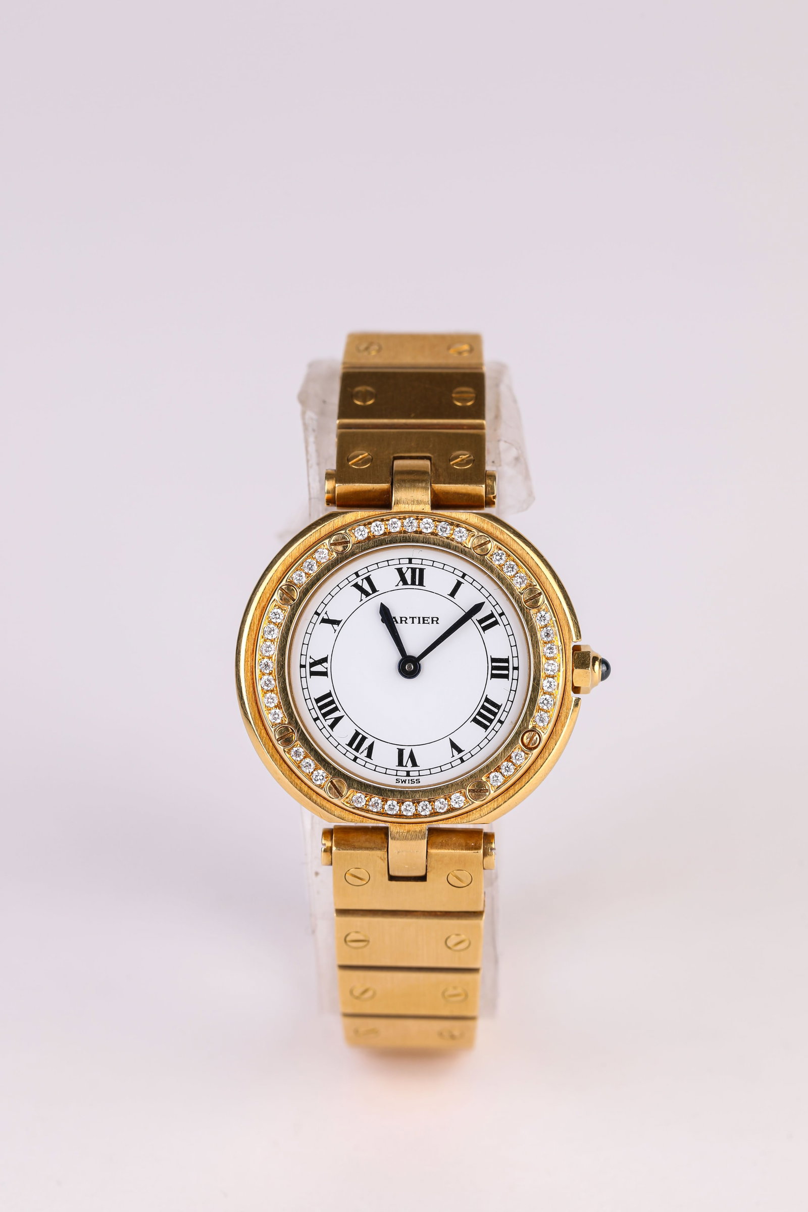 A CARTIER GOLD AND GEMSTONE WRISTWATCH: A CARTIER GOLD AND GEMSTONE WRISTWATCH Description: Dimensions: Width: 30 mm. All measurements are approximate.