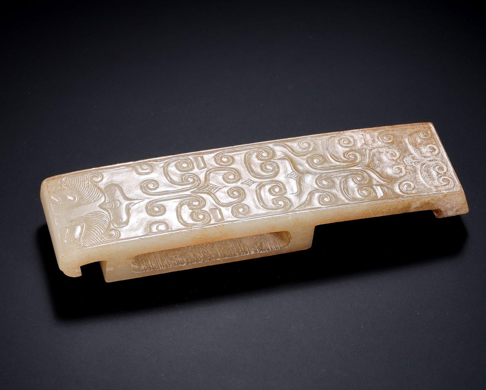 A JADE ORNAMENT: A JADE ORNAMENT Description: Dimensions: Width: 10.8 cm x Height: 2.6 cm. All measurements are approximate.