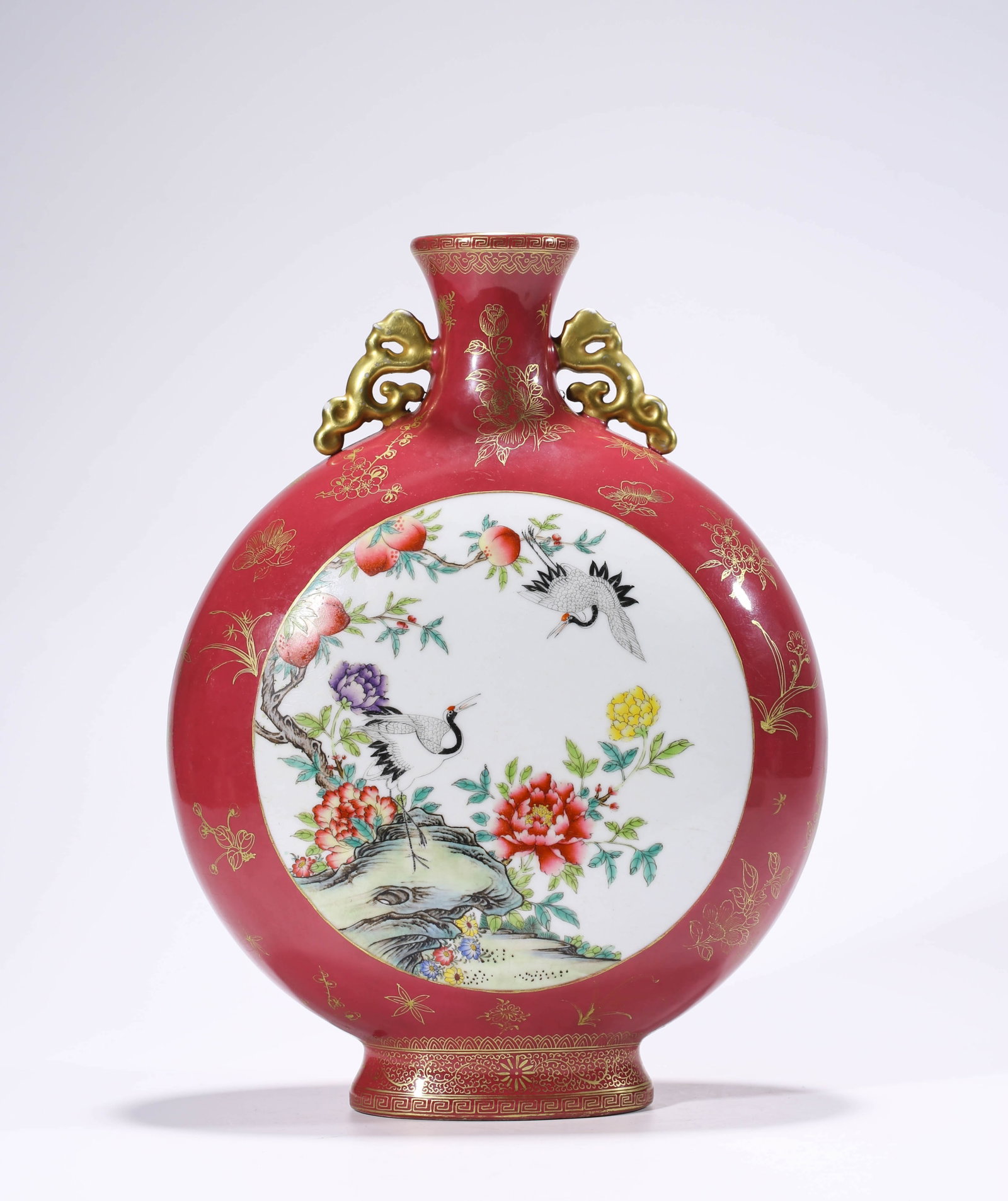 A ROUGE-GROUND FAMILLE-ROSE 'FLORAL RESERVES' MOONFLASK: A ROUGE-GROUND FAMILLE-ROSE 'FLORAL RESERVES' MOONFLASK Description: Dimensions: Length: 27 cm x Width: 13.8 cm x Height: 35.6 cm. All measurements are approximate.