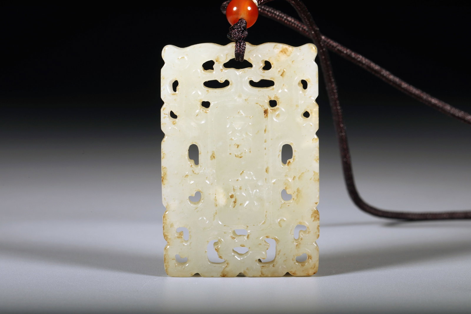 A WHITE JADE 'FASTING' PENDANT - 2