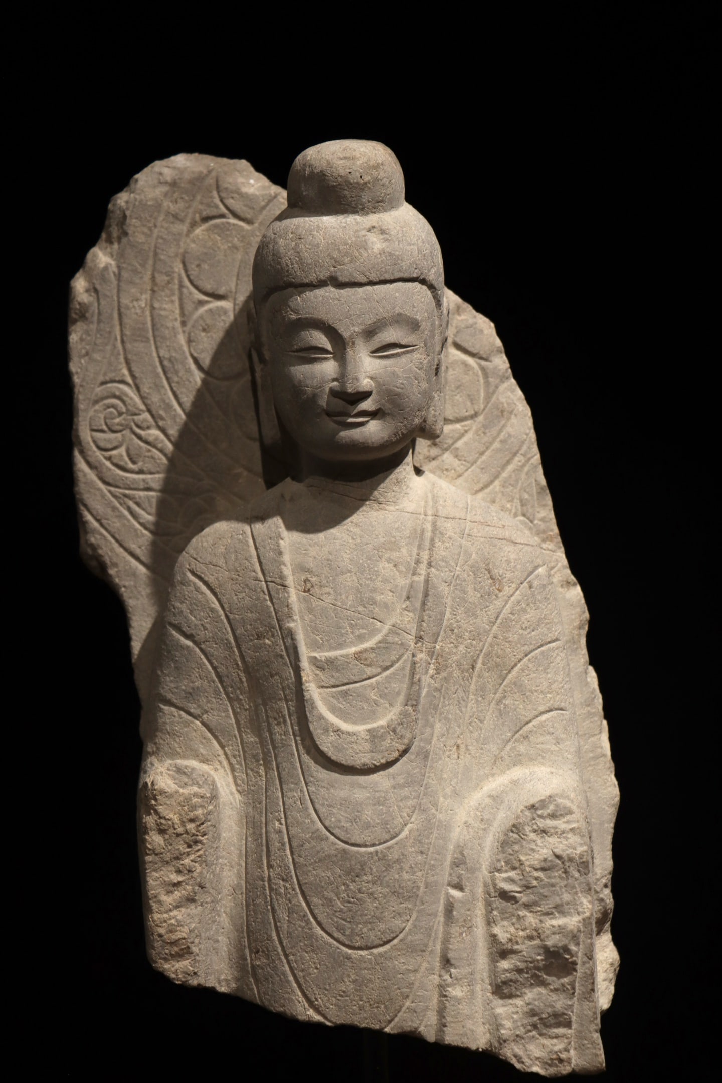 A HALF-LENGTH STONE STATUE OF SAKYAMUNI IN BLUESTONE: A HALF-LENGTH STONE STATUE OF SAKYAMUNI IN BLUESTONE (43 x 31cm)
