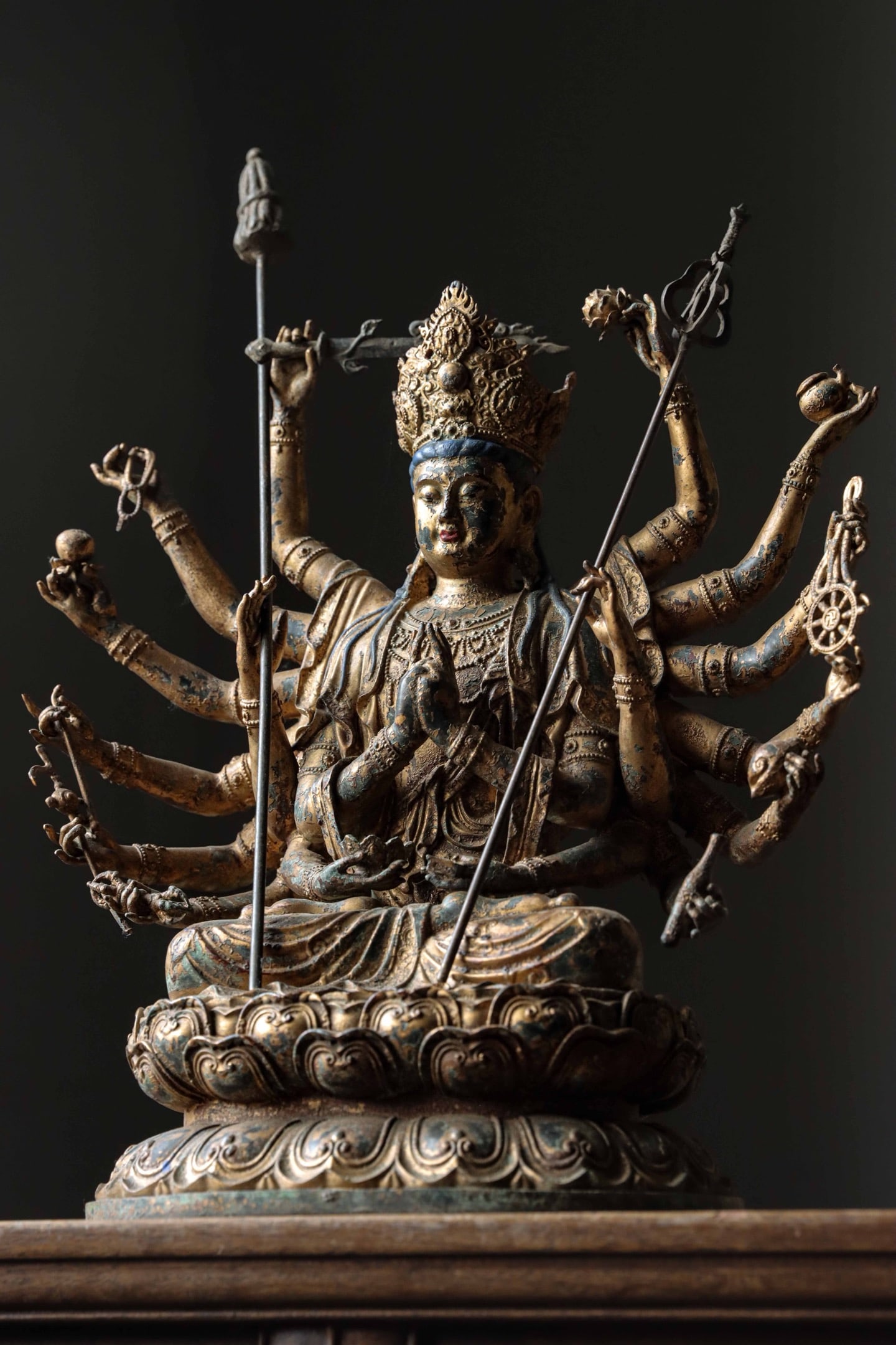 A SEATED STATUE OF THE EIGHTEEN-ARMED BODHISATTVA IN GILDED BRONZE: A SEATED STATUE OF THE EIGHTEEN-ARMED BODHISATTVA IN GILDED BRONZE (11.68lb)(41 x 31 x 19cm,Weight:5300g)