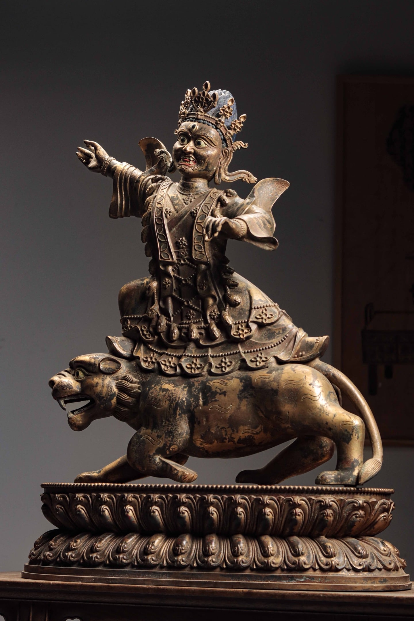 BRONZE GILT RIDING A LION TO PROTECT THE GOD OF WEALTH: BRONZE GILT RIDING A LION TO PROTECT THE GOD OF WEALTH (81 x 63 x 26cm,Weight:30000g)