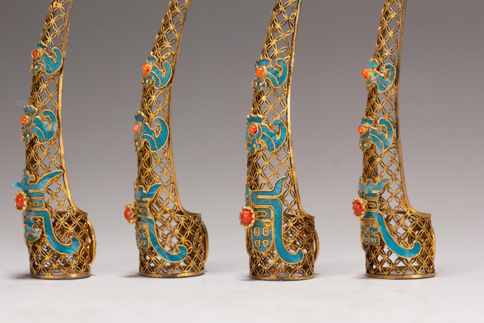 FOUR CHINESE GILT SILVER GEM-SET NAIL GUARDS - 7