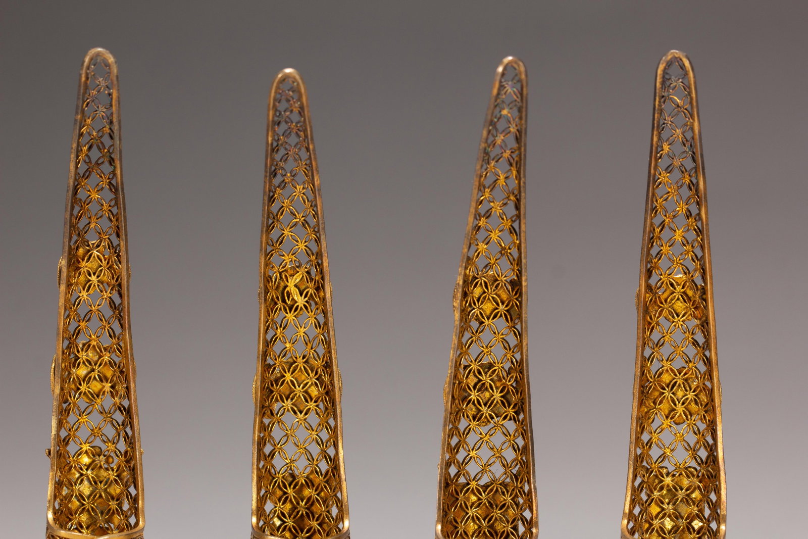 FOUR CHINESE GILT SILVER GEM-SET NAIL GUARDS - 9