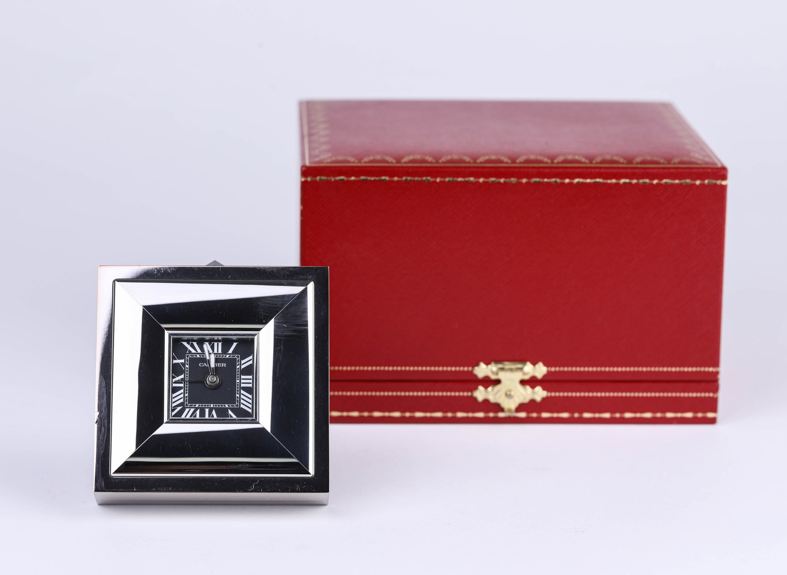 A CARTIER MANTEL CLOCK: A CARTIER MANTEL CLOCK Description: Dimensions: Weight: 430 g. Length: 7.3 cm x Width: 3 cm x Height: 7.7 cm. All measurements are approximate.
