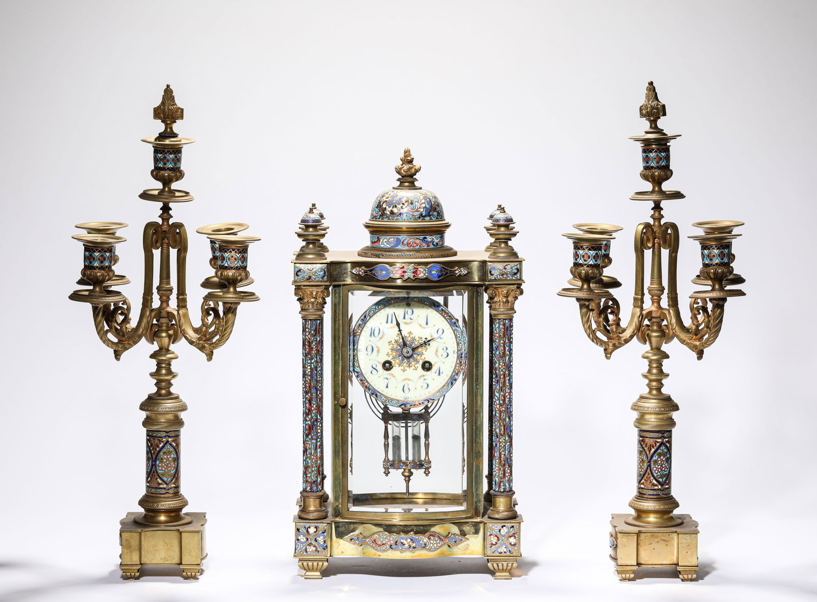 A GROUP OF GILT-BRONZE CLOISONN? ENAMEL MANTEL CLOCK AND CANDLEHOLDERS: A GROUP OF GILT-BRONZE CLOISONNE ENAMEL MANTEL CLOCK AND CANDLEHOLDERS Description: Dimensions: Weight: 7650 g. Length: 22 cm x Width: 15.2 cm x Height: 41.6 cm. Weight: 5450 g. Width: 23.3 cm x