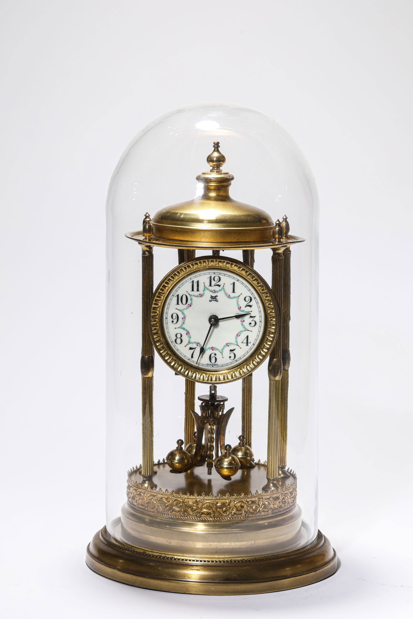 A GILT-BRONZE CLOCK: A GILT-BRONZE CLOCK Description: Dimensions: Weight: 1800 g. Width: 22.7 cm x Height: 39 cm. All measurements are approximate.