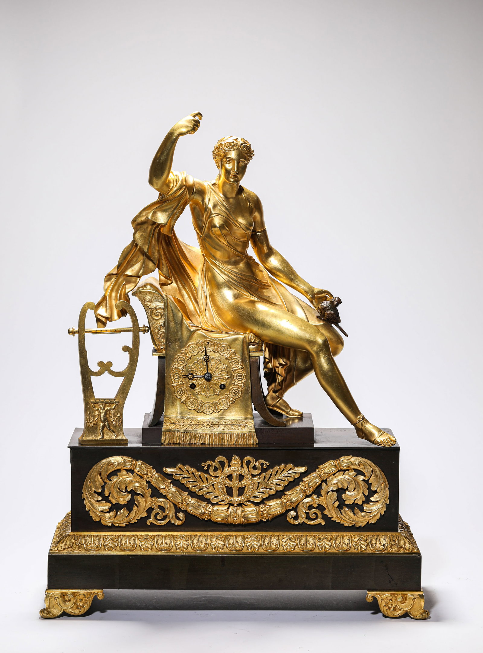 A FRENCH GILT-BRONZE 'FIGURAL' MANTEL CLOCK: A FRENCH GILT-BRONZE 'FIGURAL' MANTEL CLOCK Description: Dimensions: Weight: 15400 g. Length: 44 cm x Width: 17.5 cm x Height: 57 cm. All measurements are approximate.