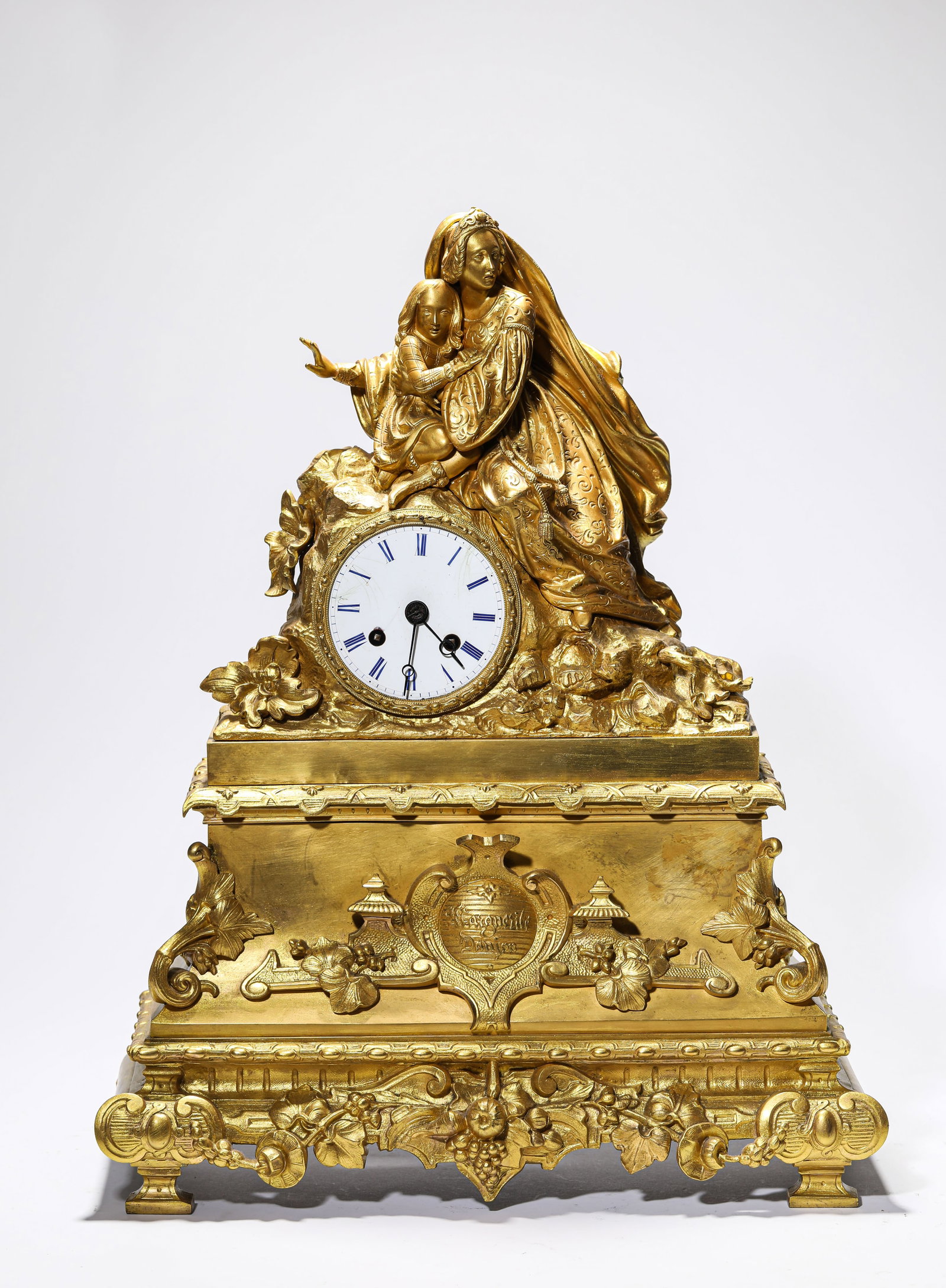 A FRENCH GILT-BRONZE CLOCK: A FRENCH GILT-BRONZE CLOCK Description: Dimensions: Weight: 9800 g. Length: 39.5 cm x Width: 15.5 cm x Height: 49.5 cm. All measurements are approximate.