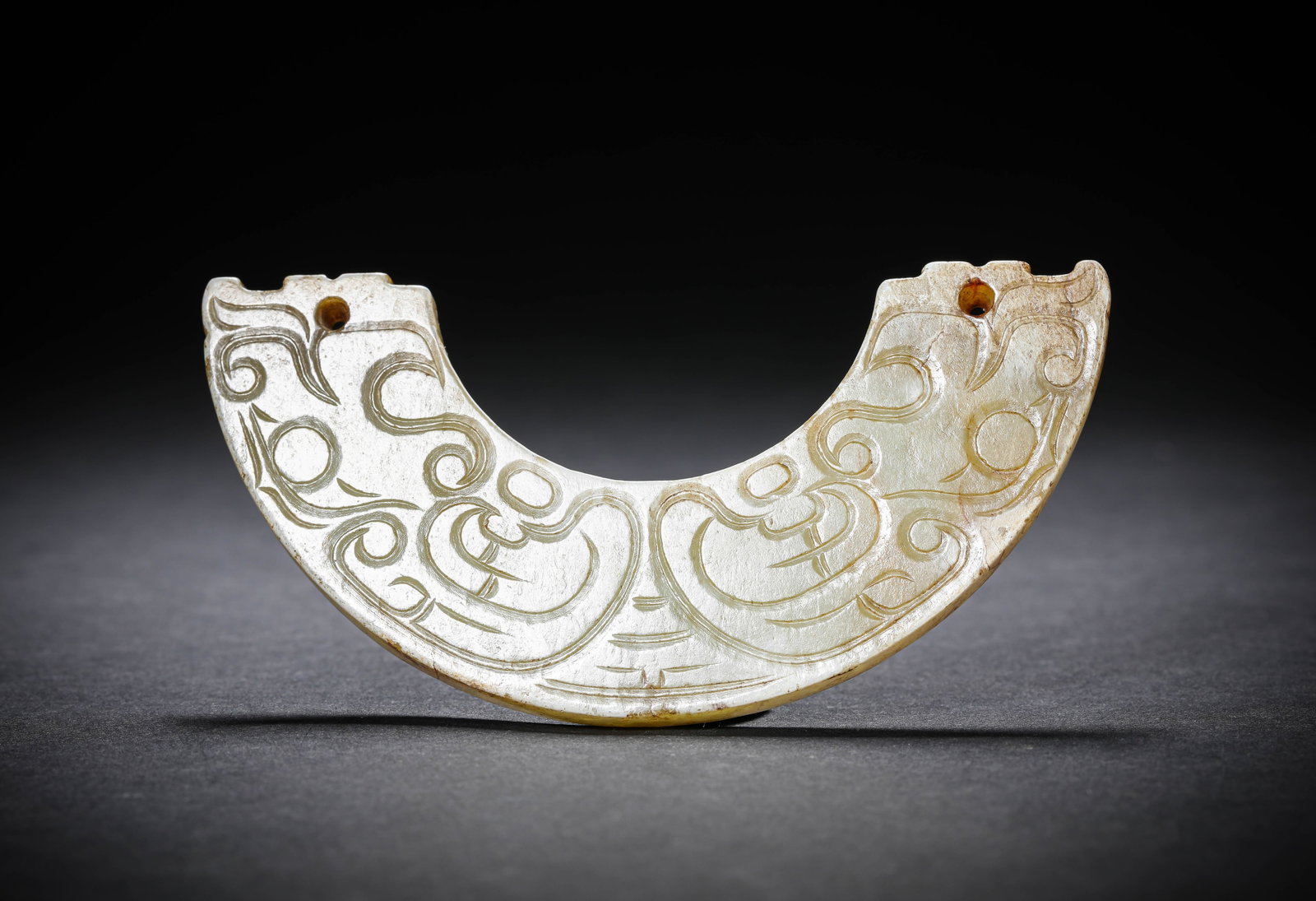 A JADE 'HUANG' PENDANT: A JADE 'HUANG' PENDANT Description: Dimensions: Width: 11.3 cm x Height: 5.5 cm. All measurements are approximate.