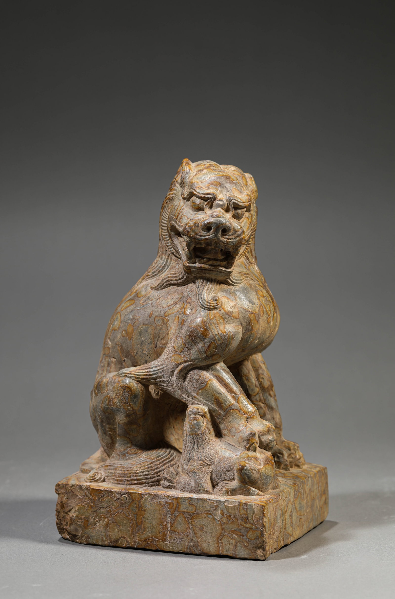A STONE LION: A STONE LION Description: Dimensions: Weight: 4000 g. Length: 13 cm x Width: 11.5 cm x Height: 22 cm. All measurements are approximate.