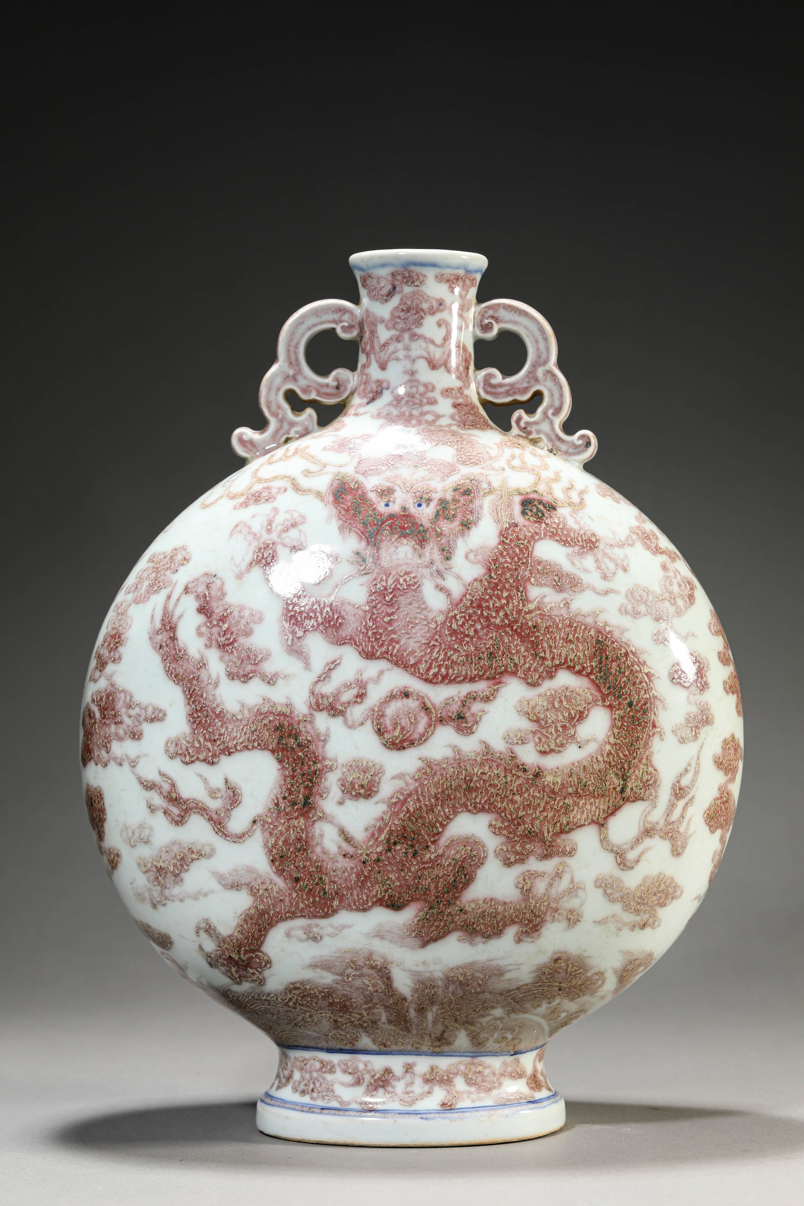 AN UNDERGLAZE-RED 'DRAGON AND CLOUDS' MOONFLASK: AN UNDERGLAZE-RED 'DRAGON AND CLOUDS' MOONFLASK Description: Dimensions: Length: 26 cm x Width: 14 cm x Height: 37.8 cm. All measurements are approximate.