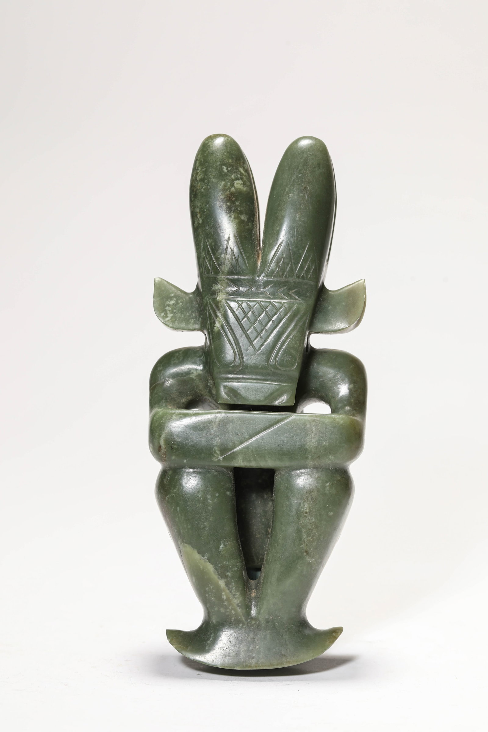 A JADE 'SUN GOD': A JADE 'SUN GOD' Description: Dimensions: Length: 8.5 cm x Width: 4 cm x Height: 20.5 cm. All measurements are approximate.