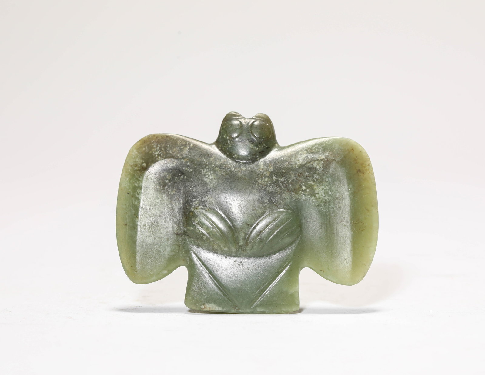 A JADE OWL: A JADE OWL Description: Dimensions: Width: 7.5 cm x Height: 5.9 cm. All measurements are approximate.