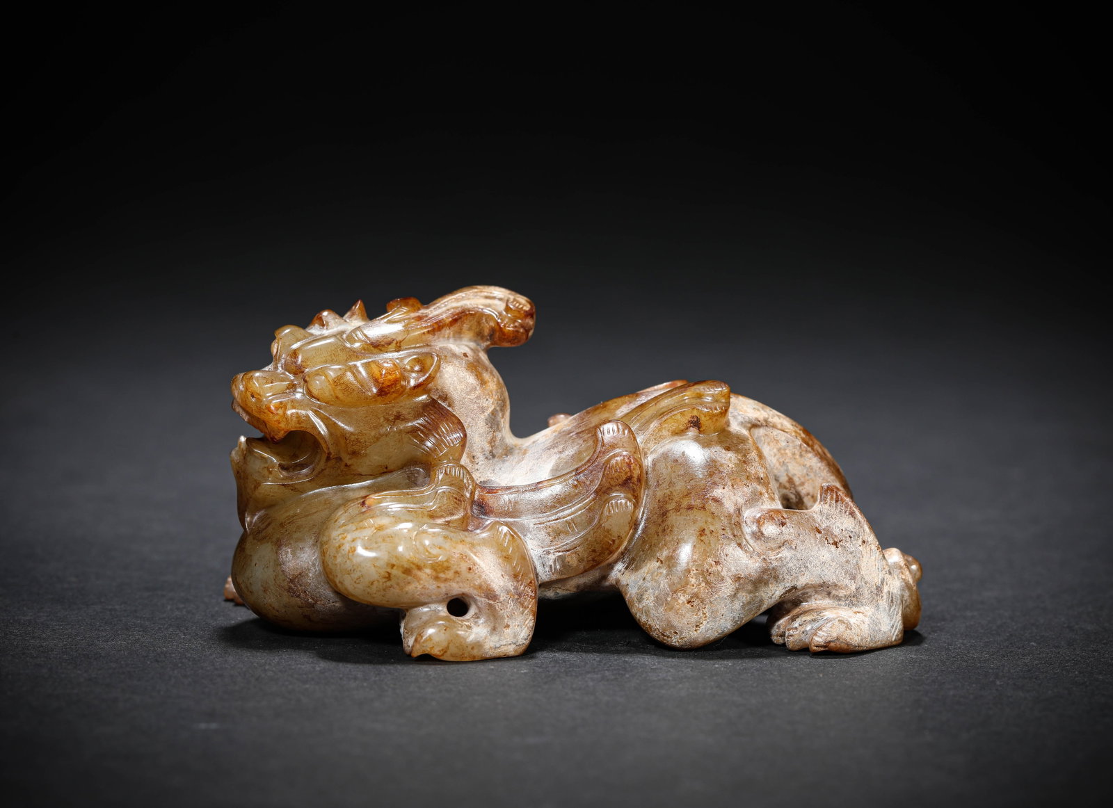 A JADE 'AUSPICIOUS BEAST': A JADE 'AUSPICIOUS BEAST' Description: Dimensions: Length: 10.1 cm x Width: 5.5 cm x Height: 5 cm. All measurements are approximate.