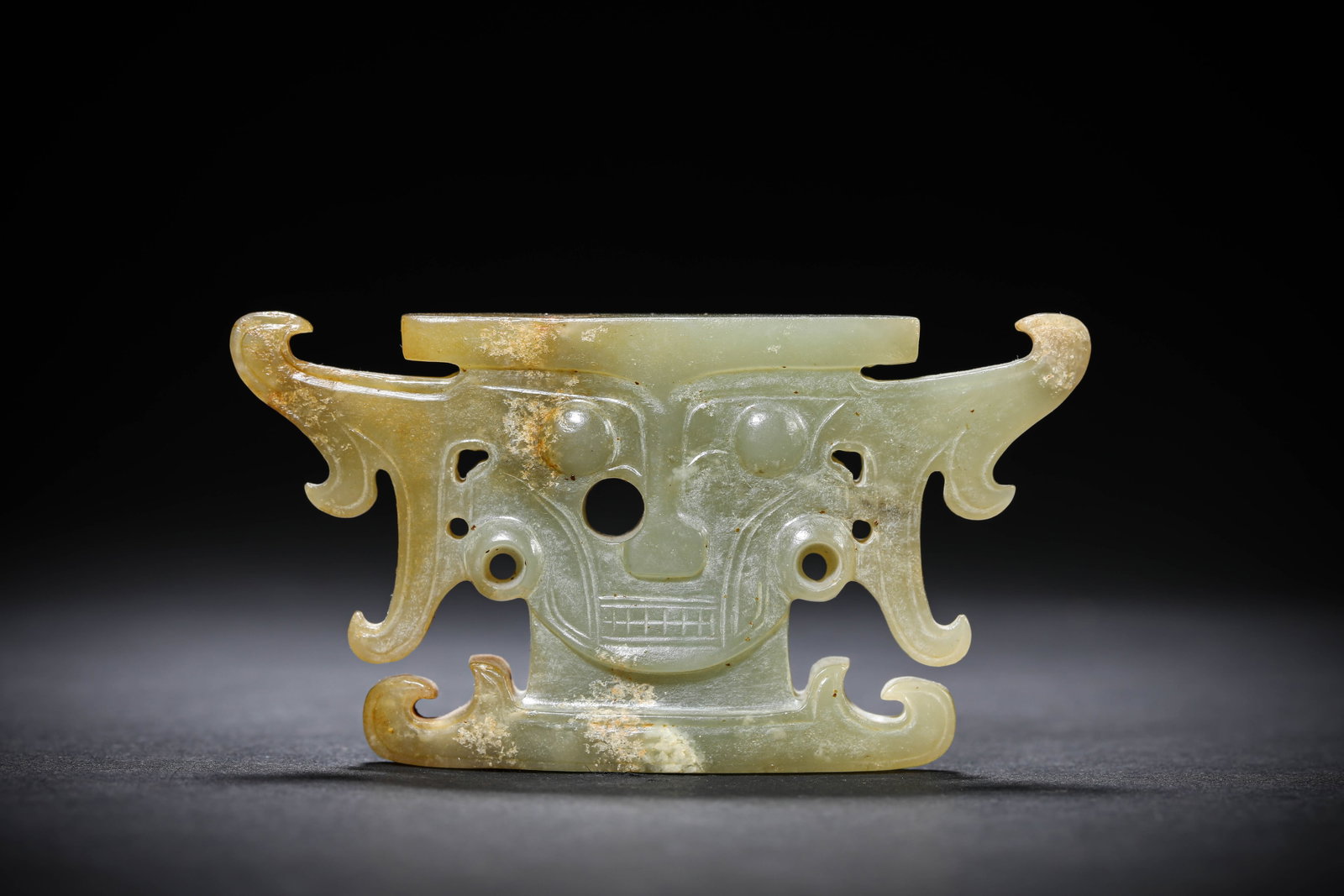 A JADE 'ANIMAL MASK' ORNAMENT: A JADE 'ANIMAL MASK' ORNAMENT Description: Dimensions: Width: 8.6 cm x Height: 4.6 cm. All measurements are approximate.