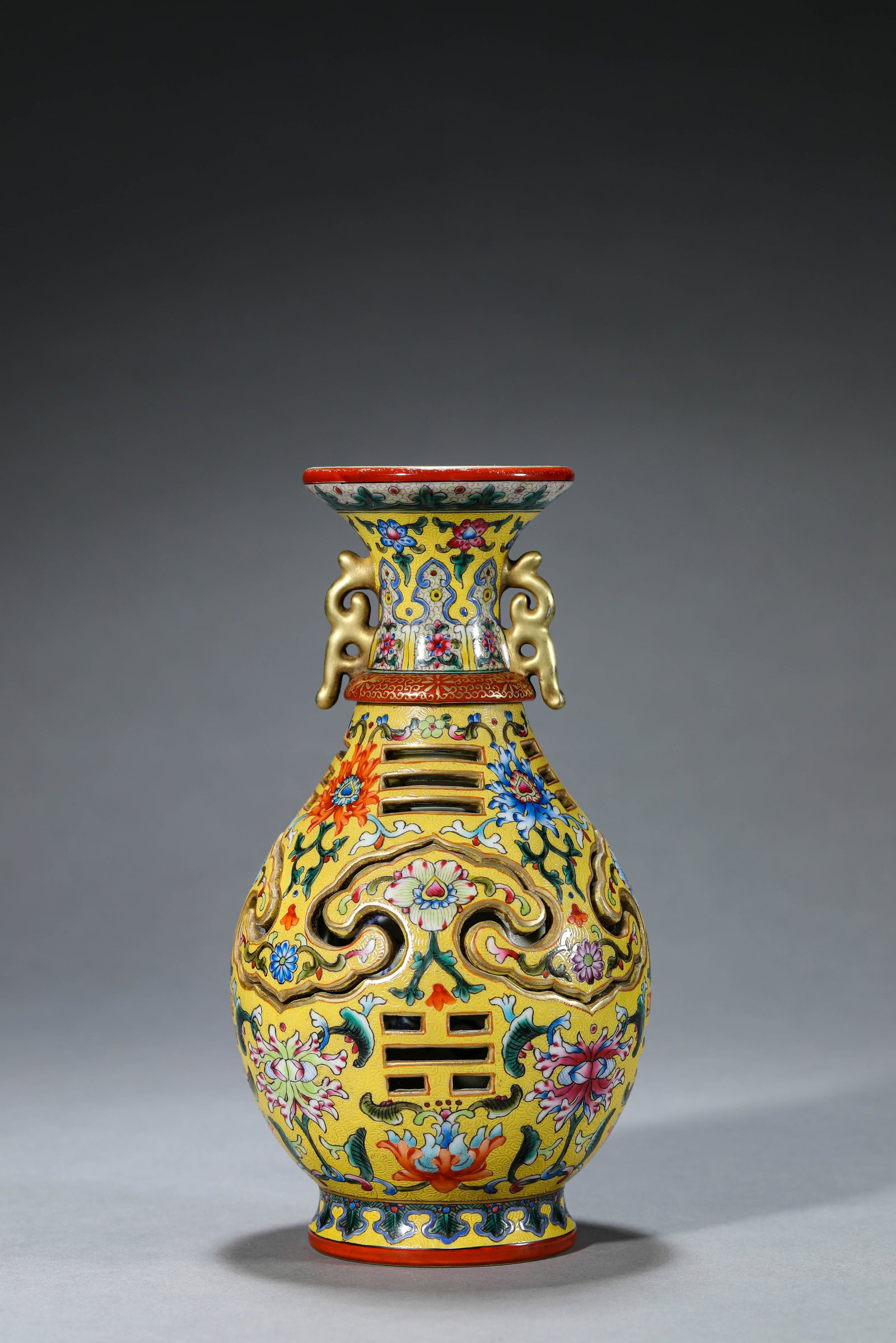 A FAMILLE-ROSE 'FLORAL AND AUSPICIOUS EMBLEMS' REVOLVING VASE: A FAMILLE-ROSE 'FLORAL AND AUSPICIOUS EMBLEMS' REVOLVING VASE Description: Dimensions: Width: 11.1 cm x Height: 20.5 cm. All measurements are approximate.