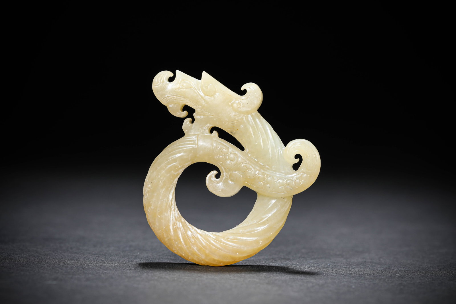 A JADE 'DRAGON' PENDANT: A JADE 'DRAGON' PENDANT Description: Dimensions: Length: 5.7 cm x Width: 1 cm x Height: 5.5 cm. All measurements are approximate.