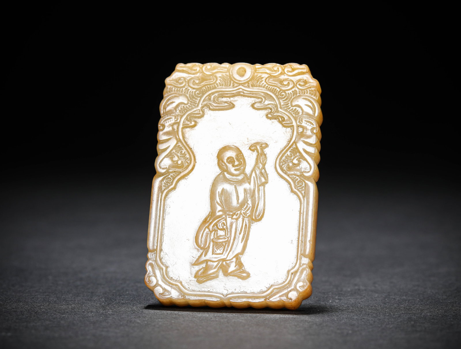 A JADE 'CARVED FIGURE' PLAQUE: A JADE 'CARVED FIGURE' PLAQUE Description: Dimensions: Length: 4.1 cm x Width: 0.7 cm x Height: 6.3 cm. All measurements are approximate.