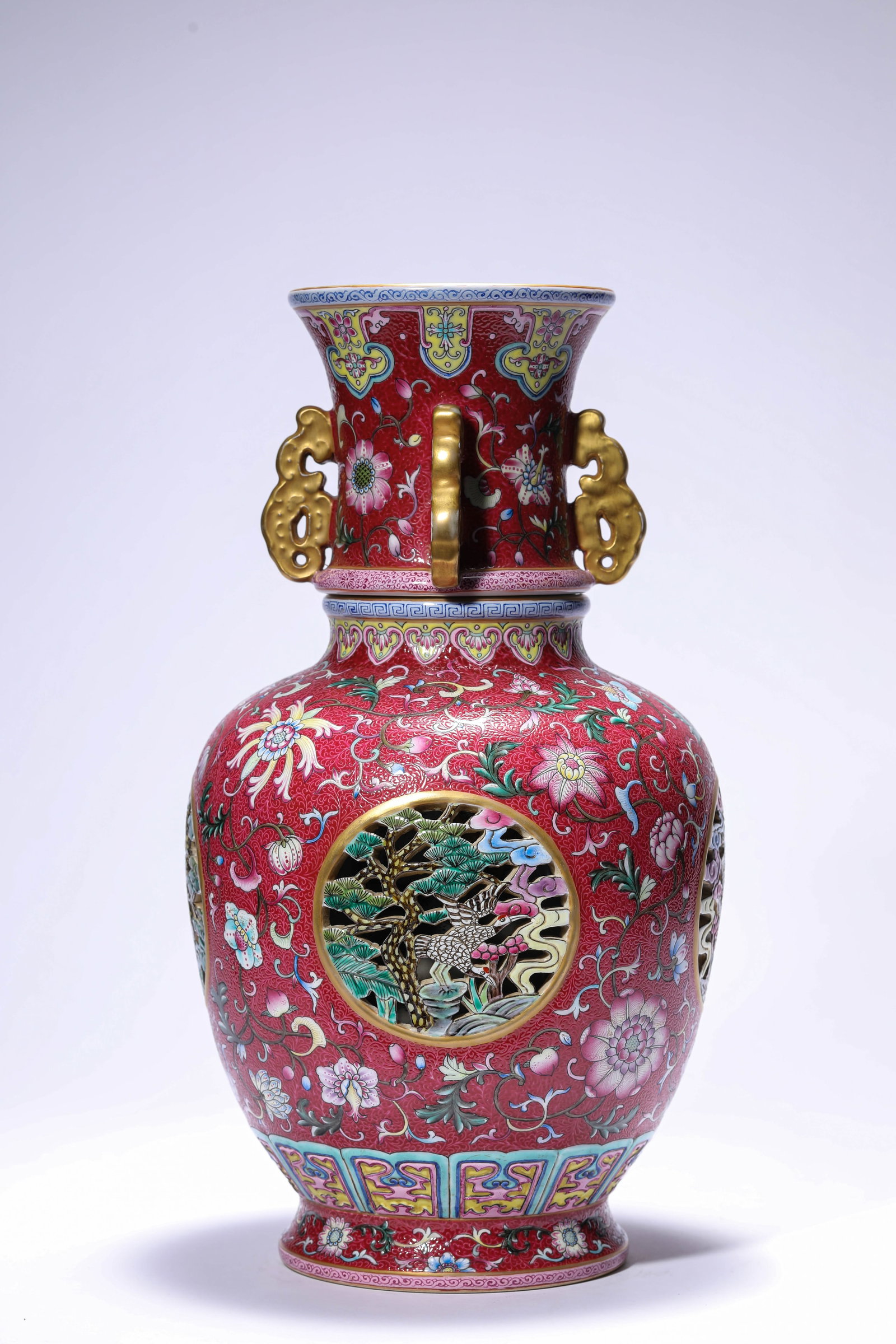 A ROUGE-GROUND FAMILLE-ROSE 'FLORAL, PINE AND CRANE' 'REVOLVING' VASE (1 of 10)