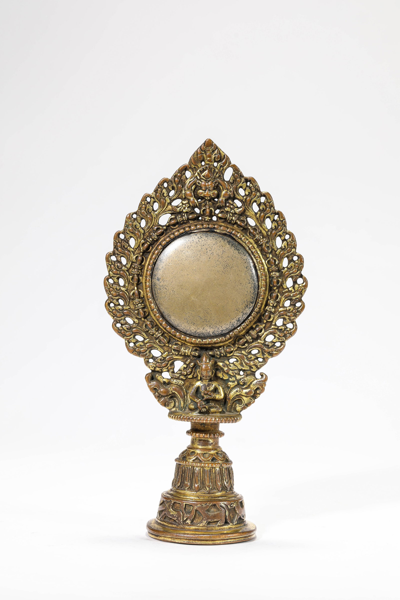 A TIBETAN 'VOTIVE' VAJRA MIRROR: A TIBETAN 'VOTIVE' VAJRA MIRROR Description: Dimensions: Weight: 875 g. Width: 11.9 cm x Height: 22.6 cm. All measurements are approximate.