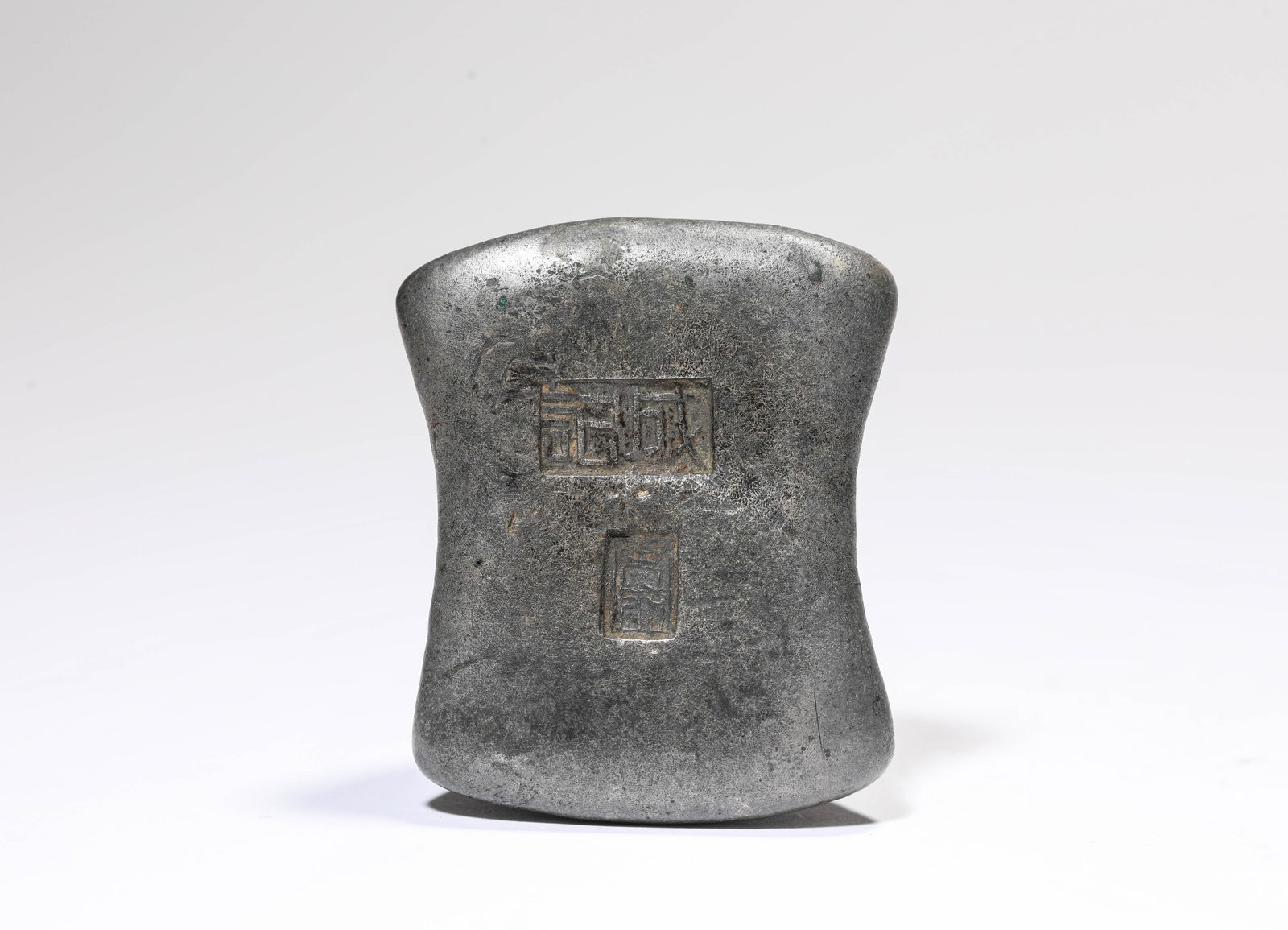 A SILVER INGOT: A SILVER INGOT Description: Dimensions: Weight: 387 g. Length: 6 cm x Width: 4.9 cm x Height: 2.9 cm. All measurements are approximate.