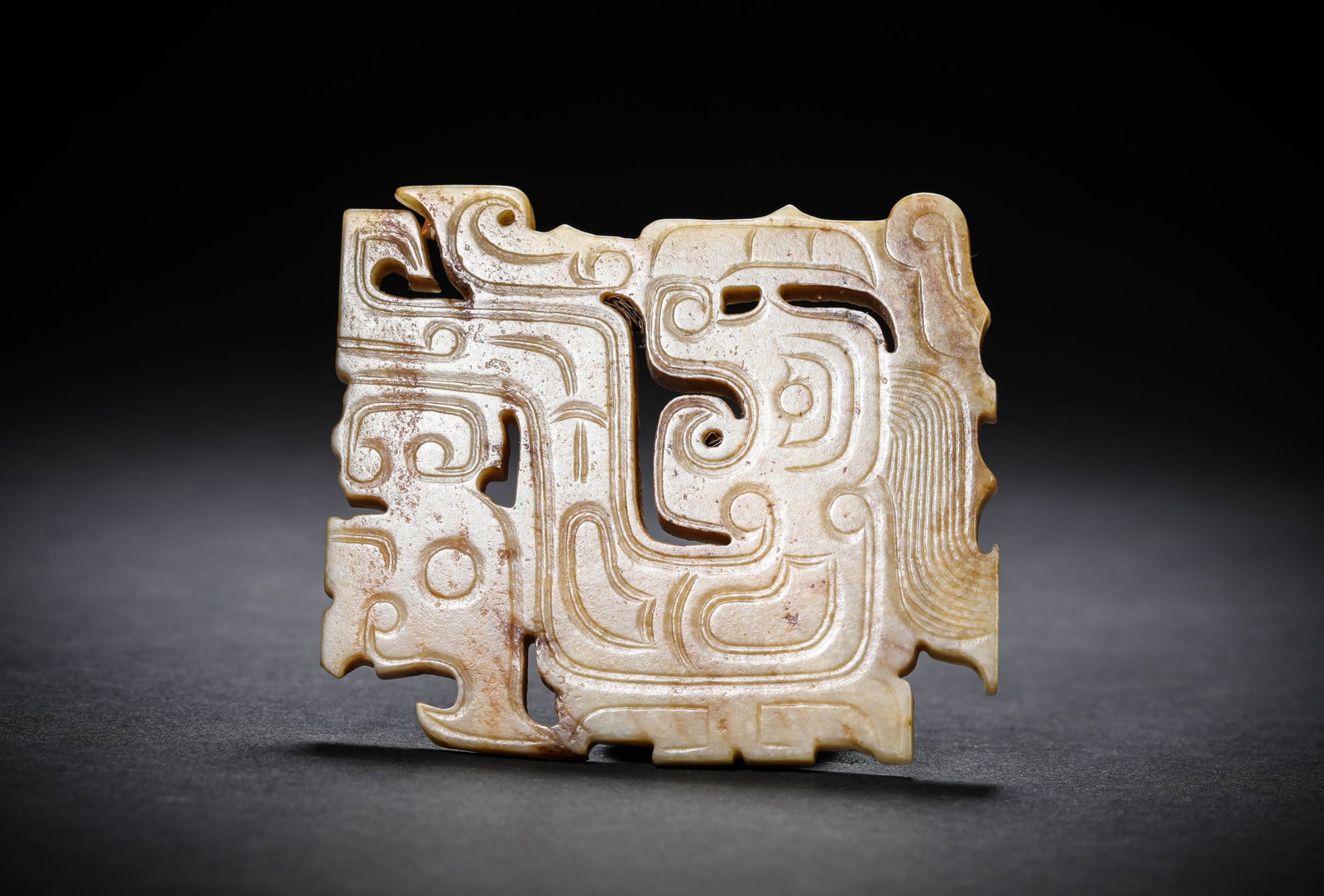 A JADE 'CARVED DRAGON AND PHOENIX' HUANG PENDANT: A JADE 'CARVED DRAGON AND PHOENIX' HUANG PENDANT Description: Dimensions: Width: 7.2 cm x Height: 6.9 cm. All measurements are approximate.