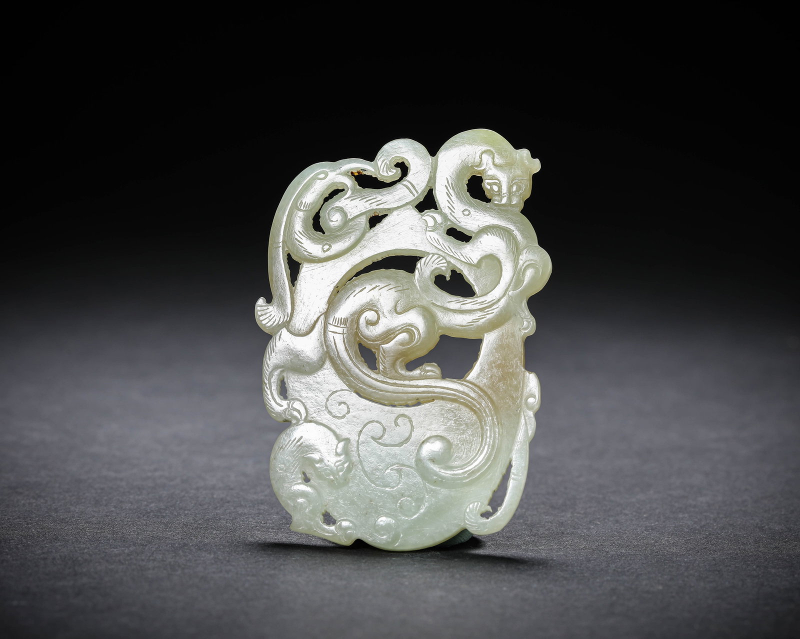 A JADE 'CARVED CHI-DRAGON' 'HEART-SHAPED' PENDANT: A JADE 'CARVED CHI-DRAGON' 'HEART-SHAPED' PENDANT Description: Dimensions: Width: 5.2 cm x Height: 7.6 cm. All measurements are approximate.
