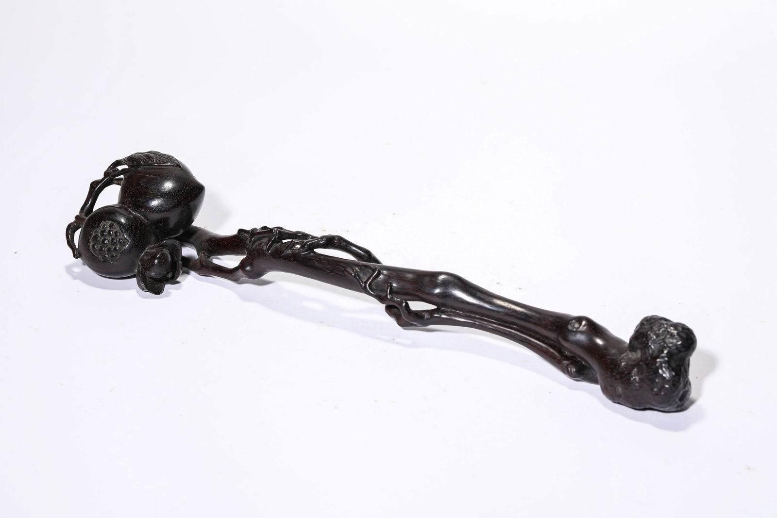 A WOOD 'CARVED' RUYI SCEPTRE: A WOOD 'CARVED' RUYI SCEPTRE Description: Dimensions: Length: 31 cm x Width: 6.8 cm x Height: 5.5 cm. All measurements are approximate.