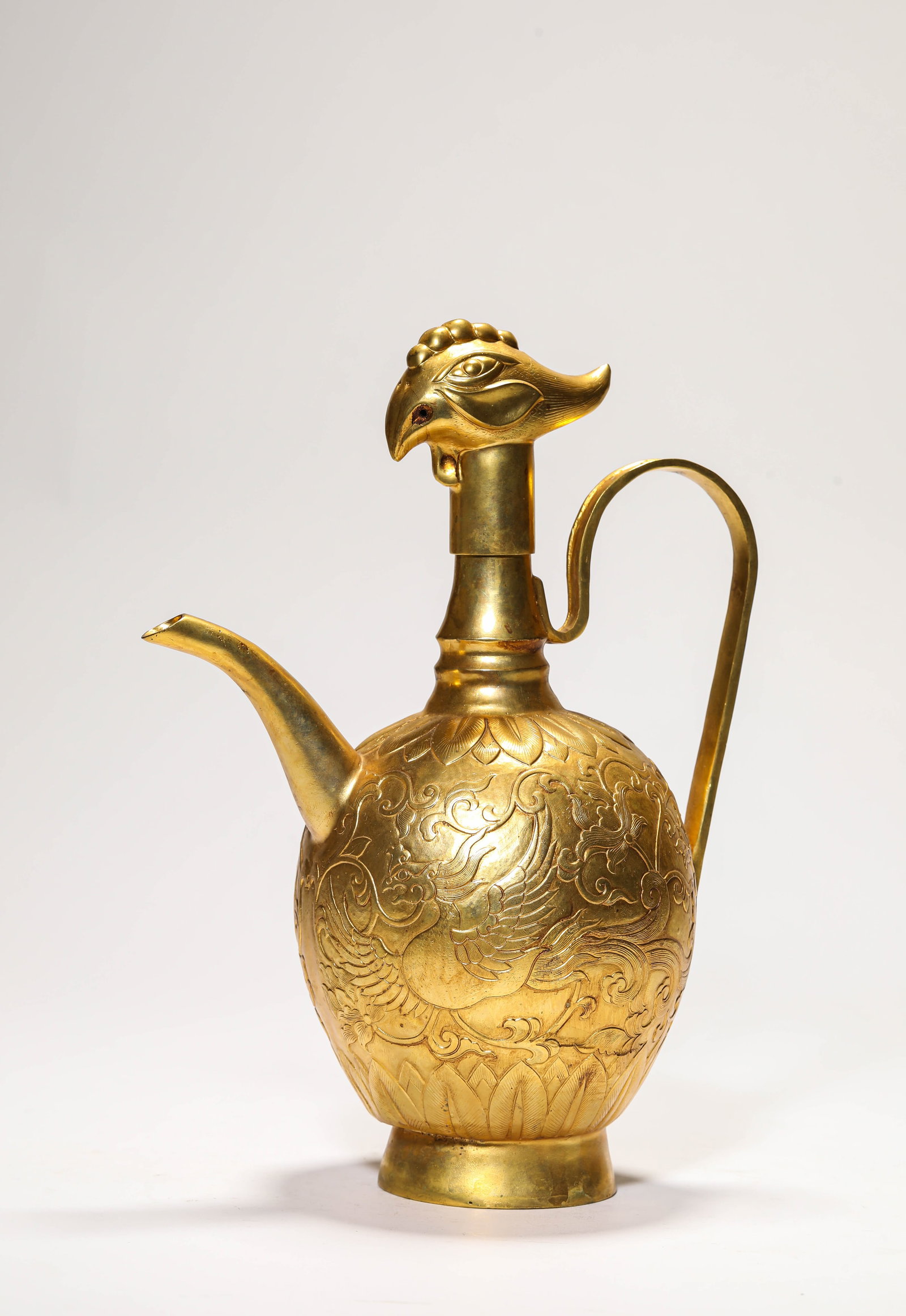 A GILT-BRONZE 'PHOENIX' EWER: A GILT-BRONZE 'PHOENIX' EWER Description: Dimensions: Weight: 833 g. Length: 18.5 cm x Width: 11.5 cm x Height: 24.8 cm. All measurements are approximate.