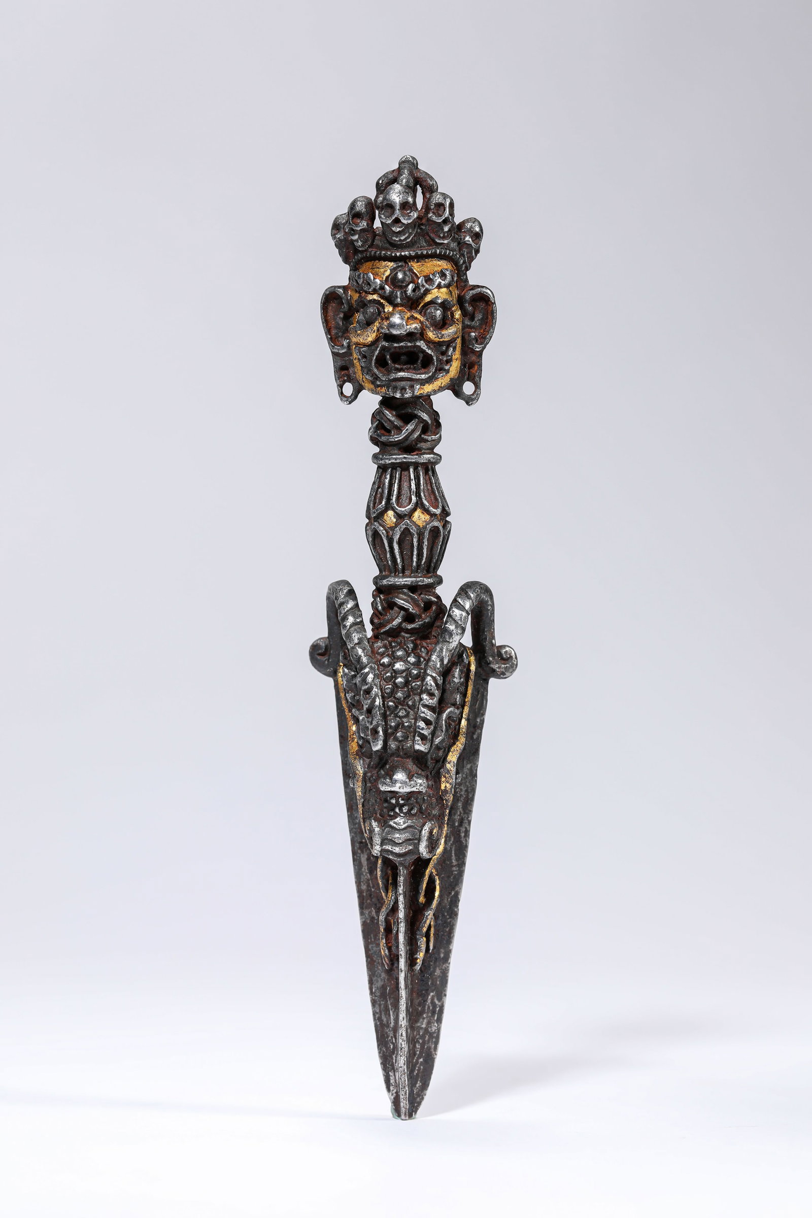 AN IRON AND GOLD CHAMPLEVe PHURBA: AN IRON AND GOLD CHAMPLEVE PHURBA Description: Dimensions: Weight: 222 g. Width: 3.8 cm x Height: 17.2 cm. All measurements are approximate.