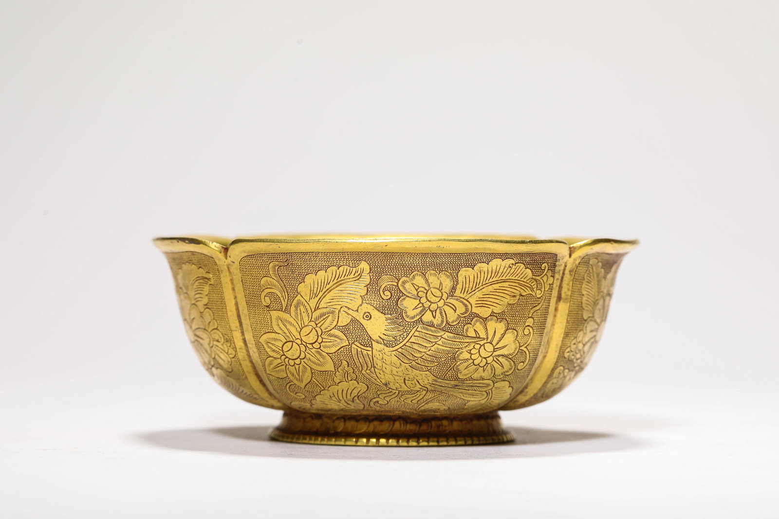 A GILT-BRONZE 'FLOWERS AND BIRDS' BOWL: A GILT-BRONZE 'FLOWERS AND BIRDS' BOWL Description: Dimensions: Weight: 360 g. Width: 12.6 cm x Height: 5.3 cm. All measurements are approximate.