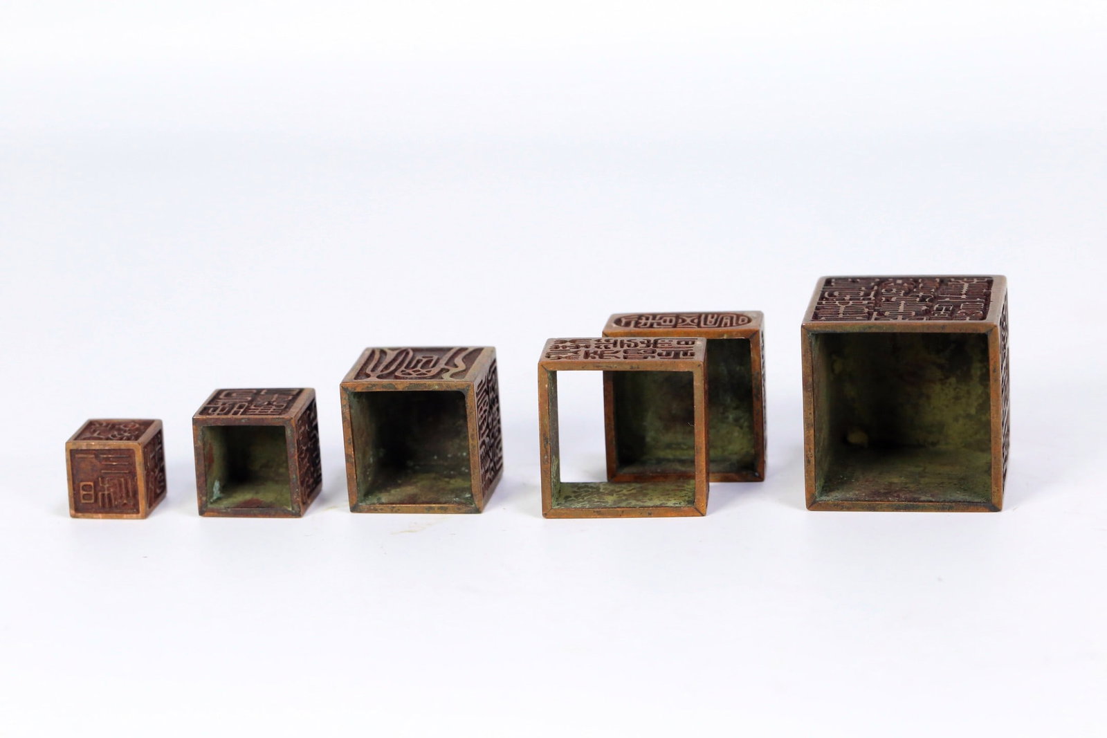 A BRONZE NESTED SEAL SET - 3