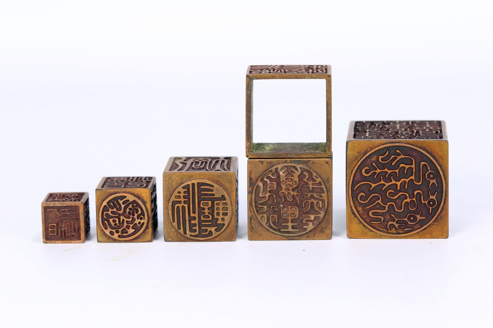 A BRONZE NESTED SEAL SET - 4