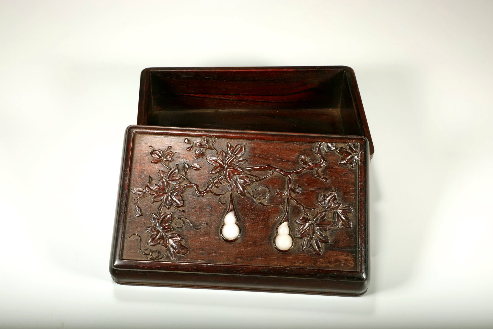 A ZITAN CARVED 'FORTUNE AND LONGEVITY' INLAID JADE BOX: A ZITAN CARVED 'FORTUNE AND LONGEVITY' INLAID JADE BOX Length:18.5cm,Width:11.5cm,Height:8.5cm