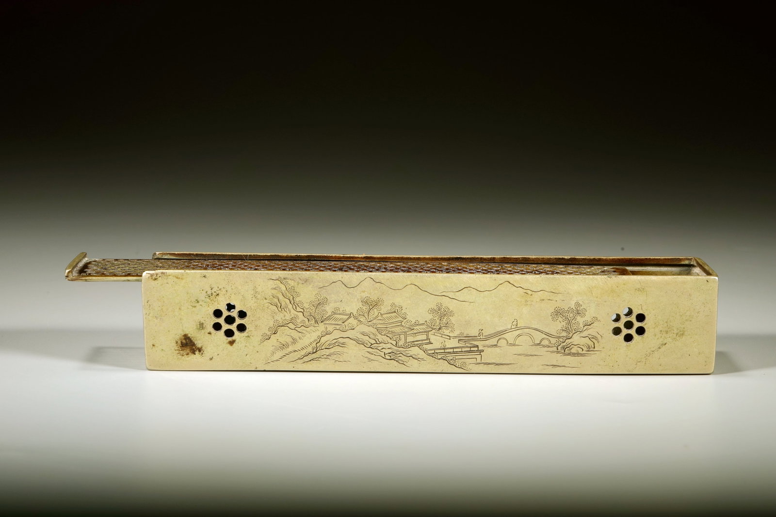 A BRONZE CARVED LANDSCAPE FIGURE INCENSE BURNER: A BRONZE CARVED LANDSCAPE FIGURE INCENSE BURNER Length:18cm,Width:4cm Height:3cm