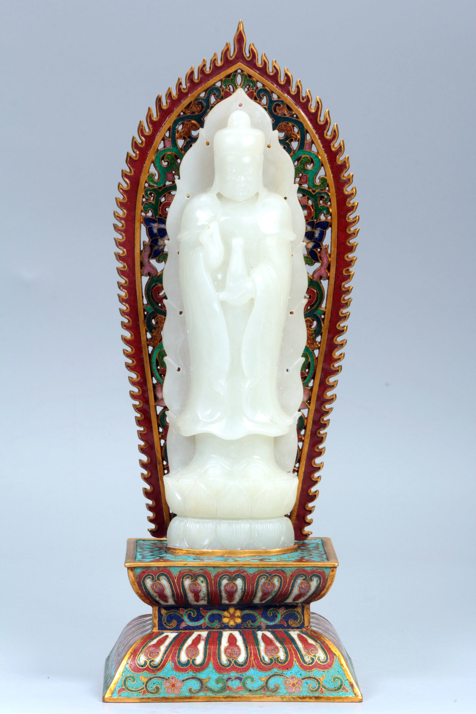 A HETIAN JADE GUANYIN FIGURE WITH CLOISONNE BASE: A HETIAN JADE GUANYIN FIGURE WITH CLOISONNE BASE Height:27.4cm,10.5*8.6cm