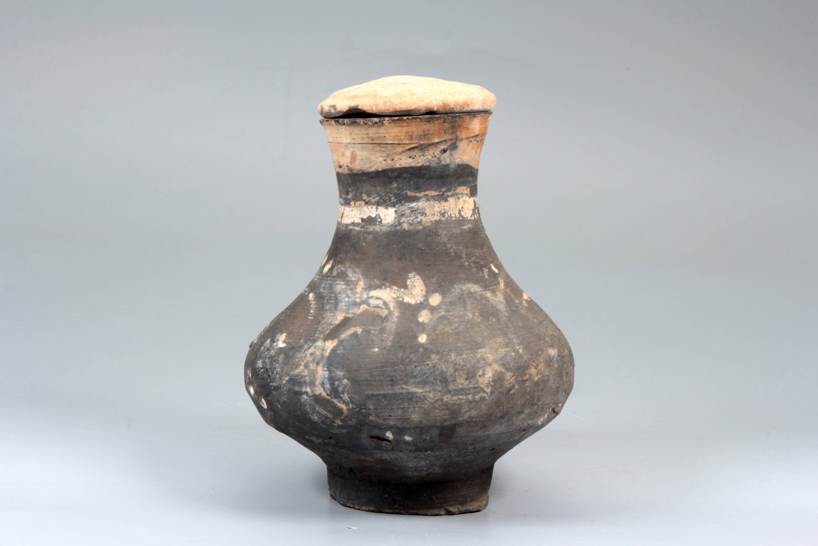 A BLACK POTTERY COVERED VASE - 4