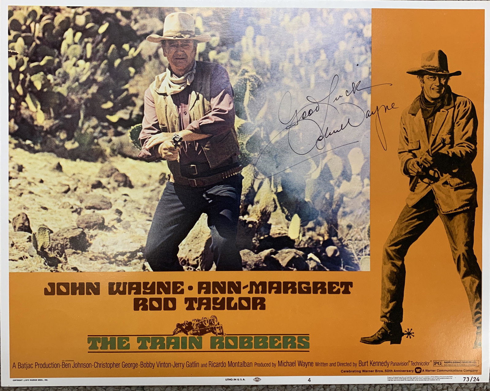 John Wayne signed The Train Robbers lobby card: John Wayne signed The Train Robbers lobby card. 11x14 inches.