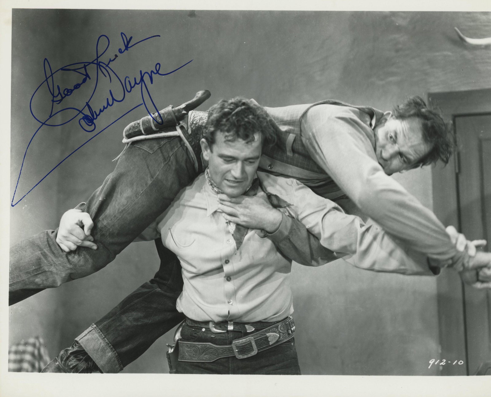 John Wayne signed movie photo: Wyoming Outlaw signed movie photo autographed by John Wayne. Photo is 8 x 10 inch