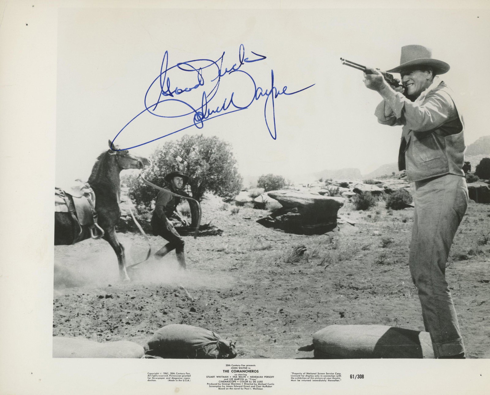 John Wayne signed movie photo: The Comancheros signed movie photo autographed by John Wayne.