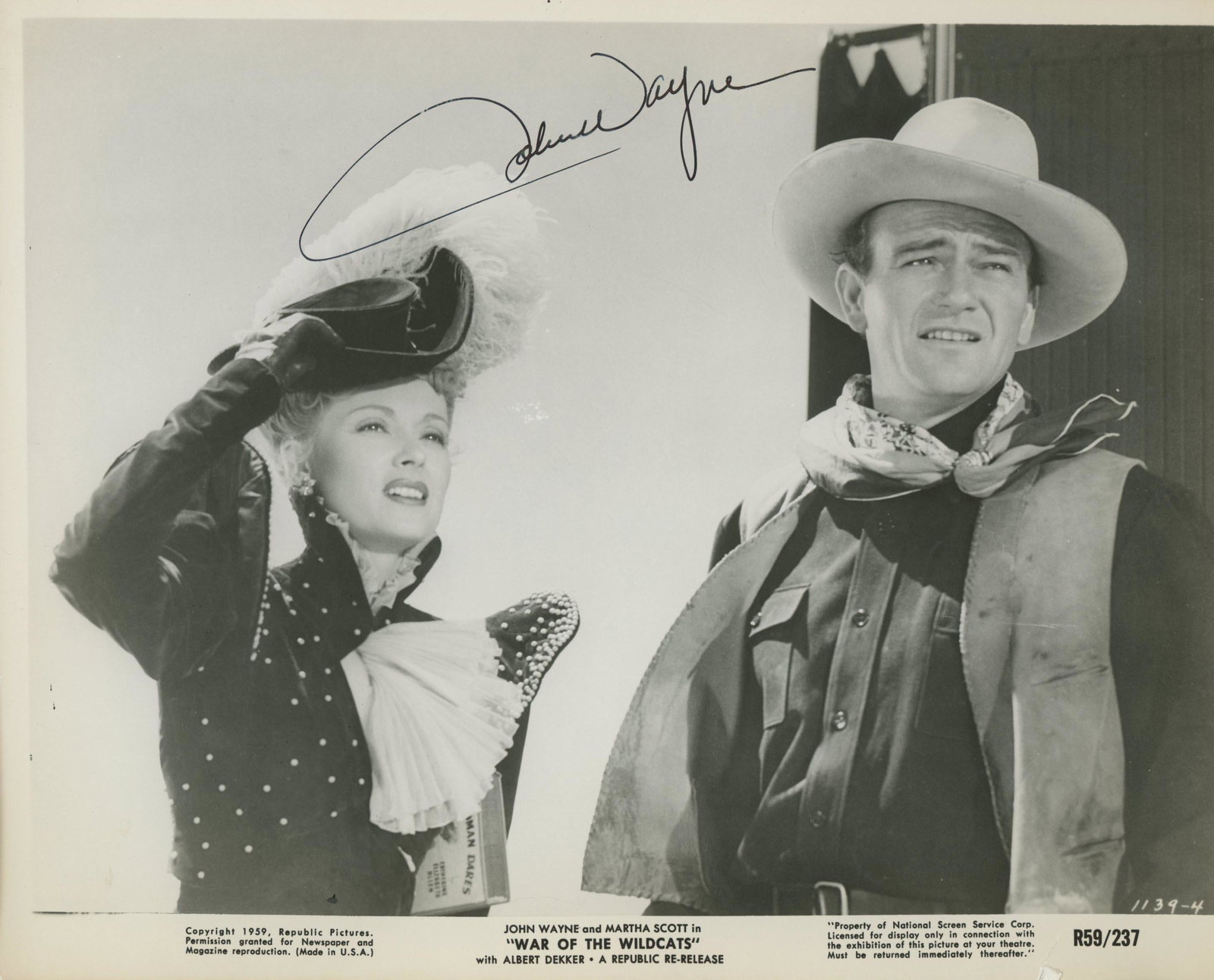 John Wayne signed movie photo: War of the Wildcats signed movie photo autographed by John Wayne. Custom framed, matted 11x14 inches.